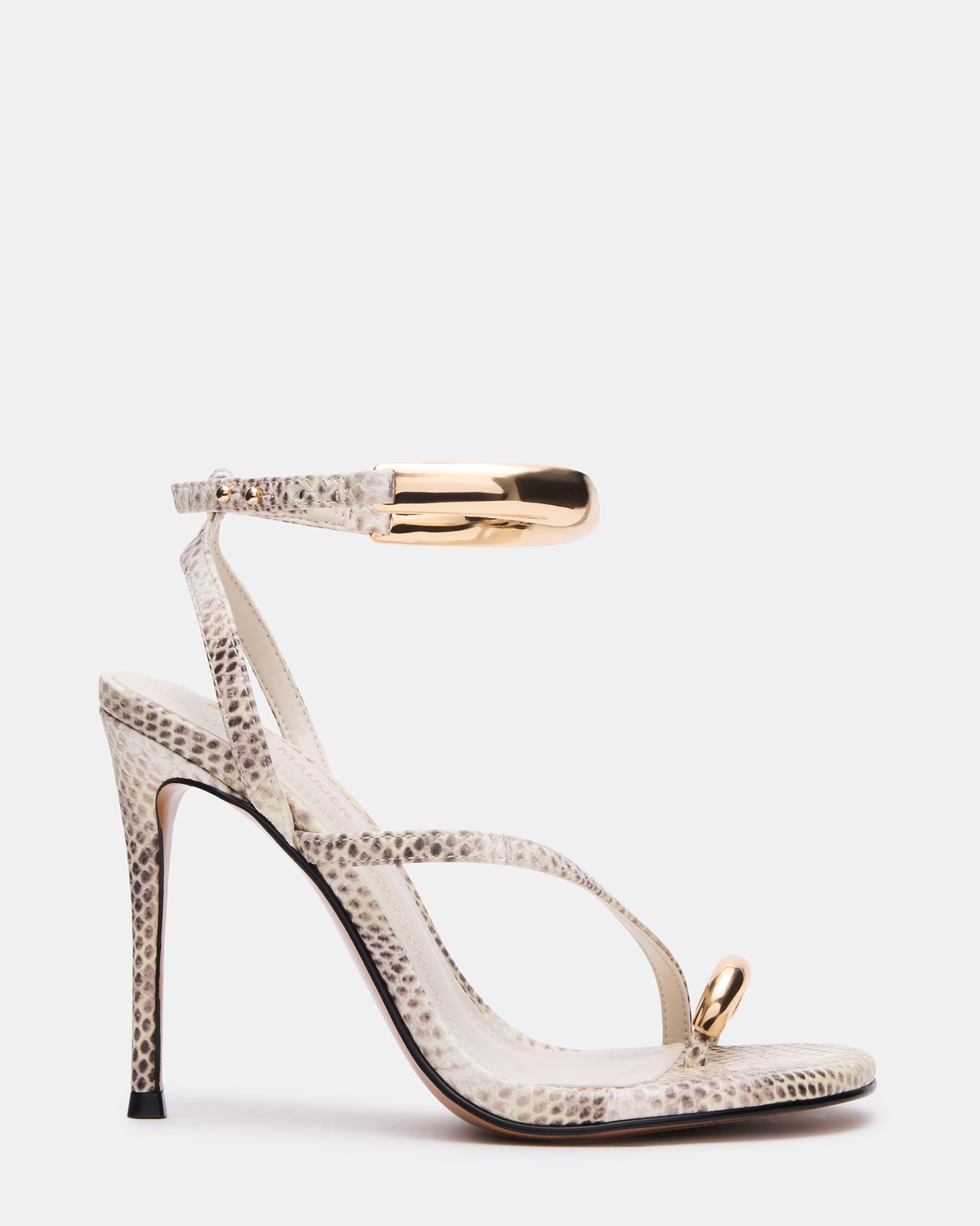 Close-up of TIA nude strappy heels showcasing gold hardware.