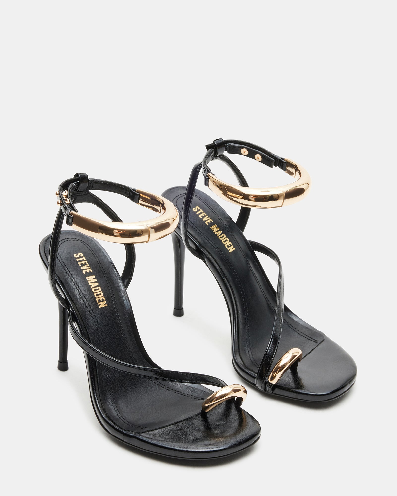 Elegant black statement heels with gold hardware for evening wear