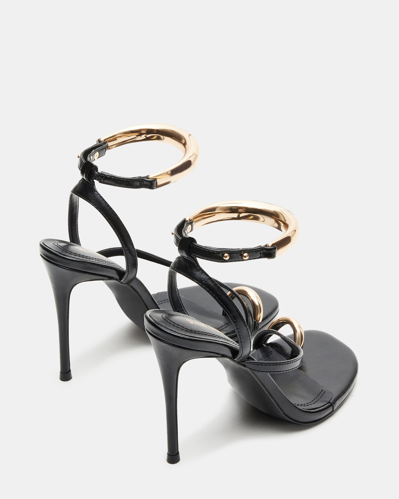 Elegant black statement heels with gold hardware for evening wear