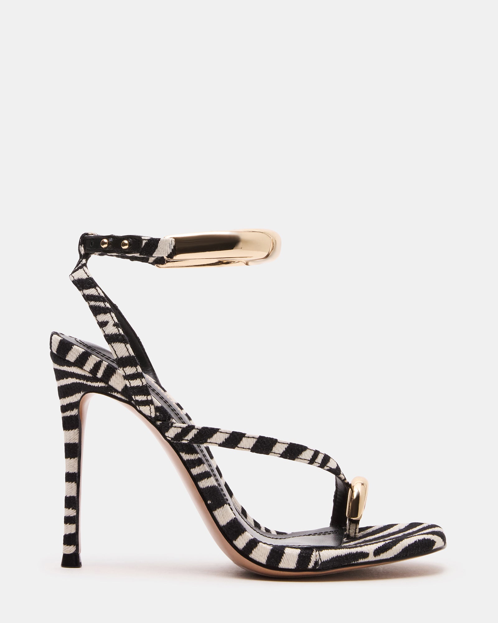 Side view of elegant gold strappy heels, showcasing the stiletto design.