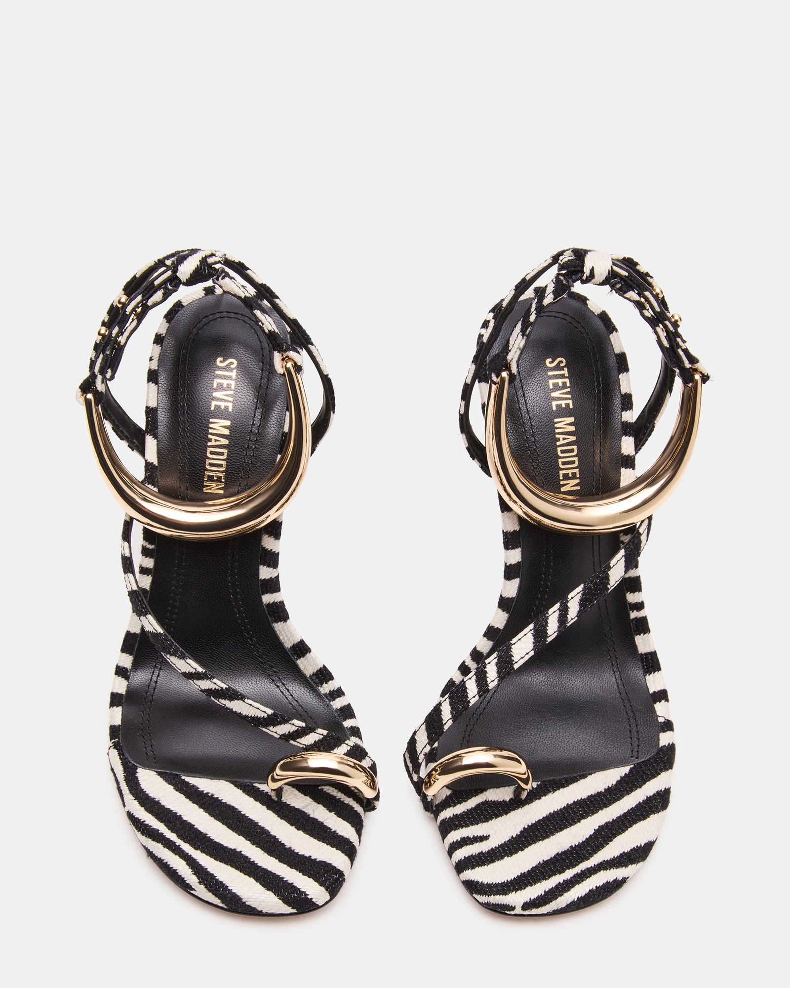 Close-up of gold hardware accents on strappy heels, perfect for special occasions.
