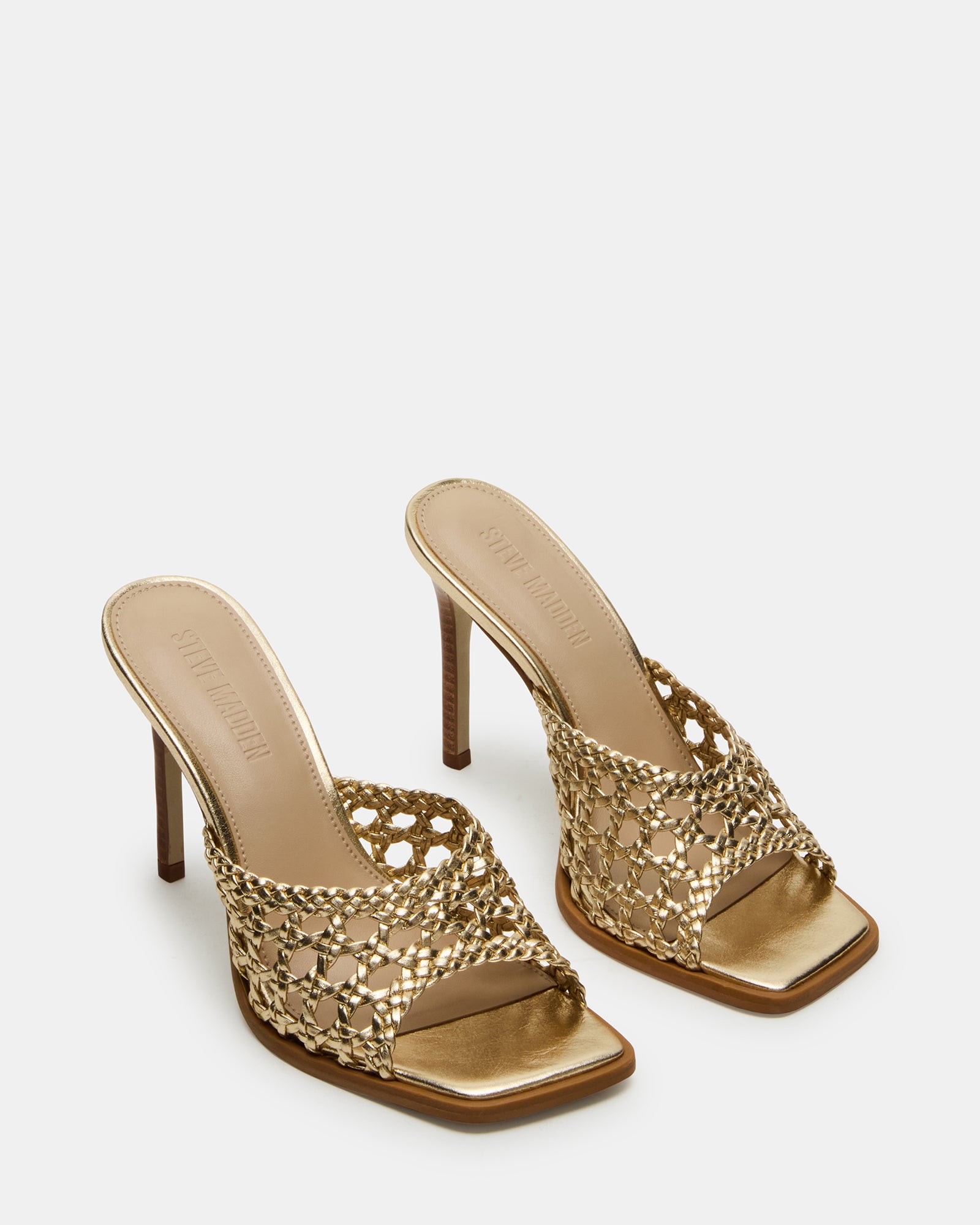 Close-up of the leather texture and gold accents on the kitten heel mules