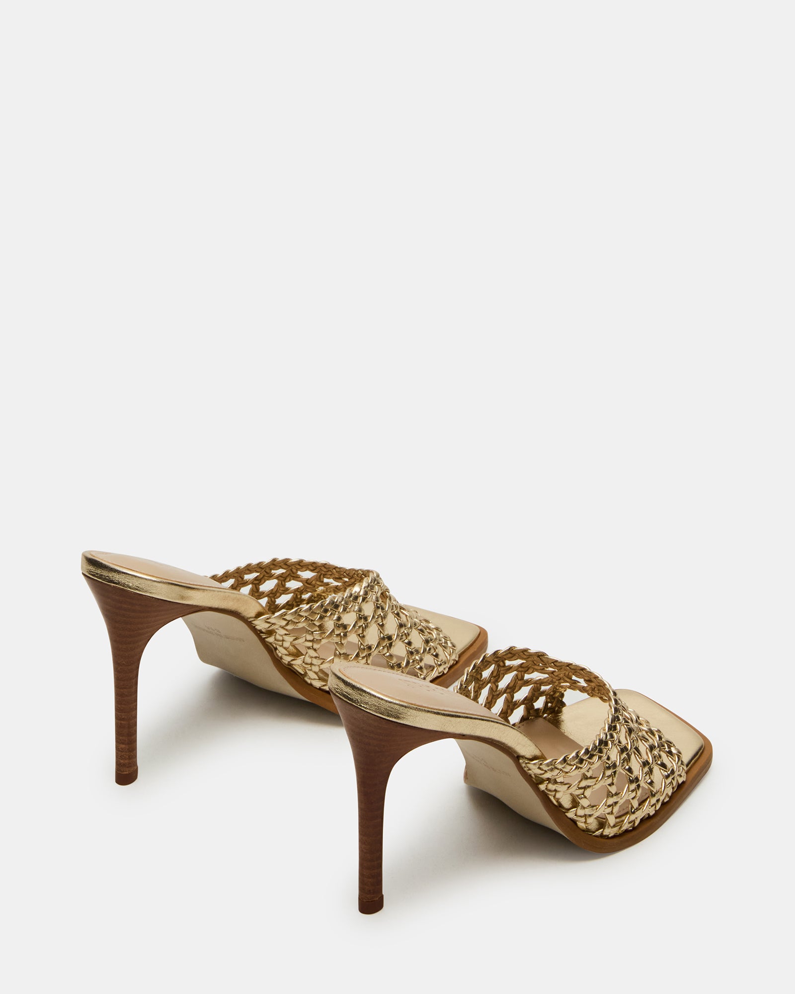 Close-up of the leather texture and gold accents on the kitten heel mules