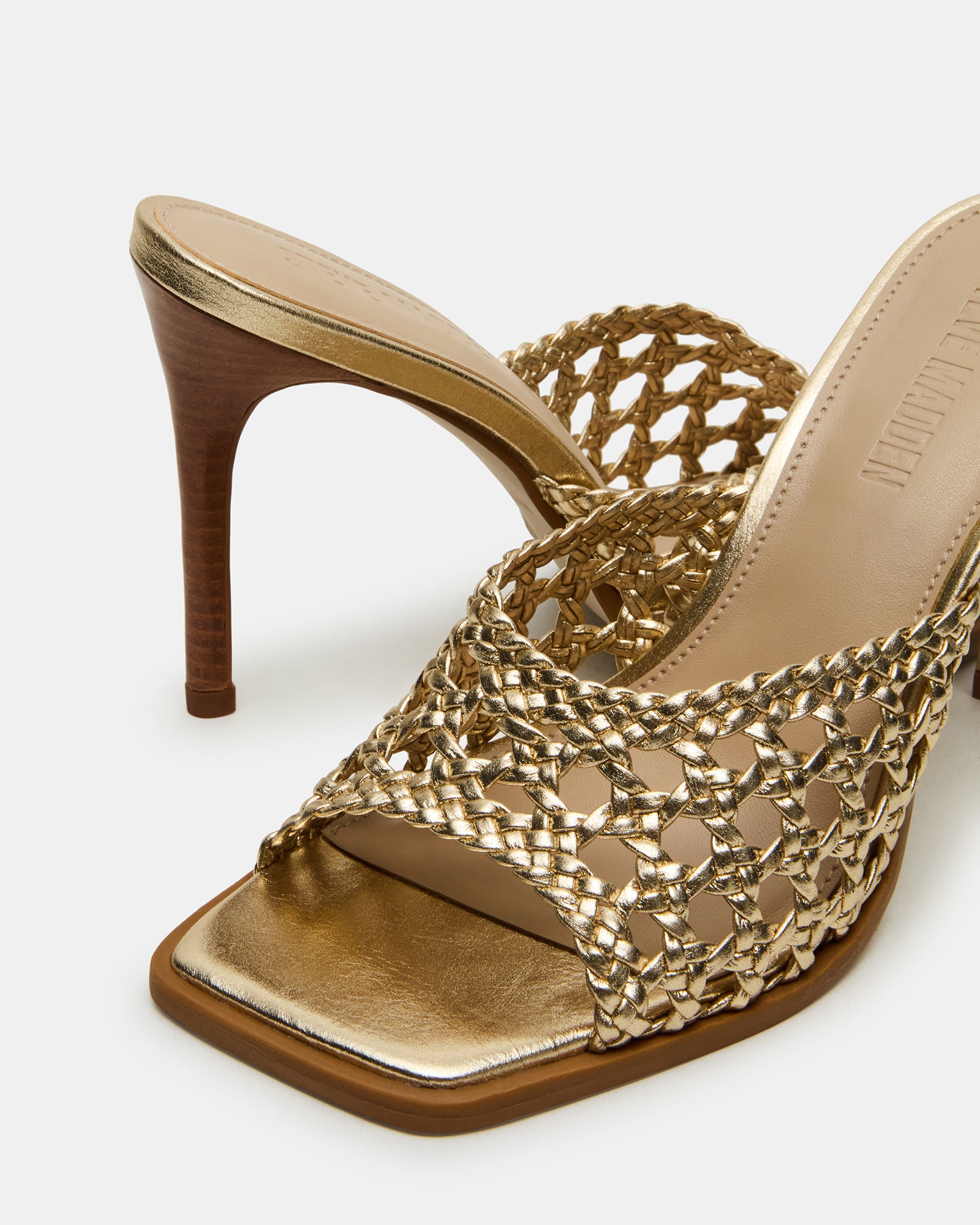 White mule high heels styled with a neutral-toned outfit for inspiration