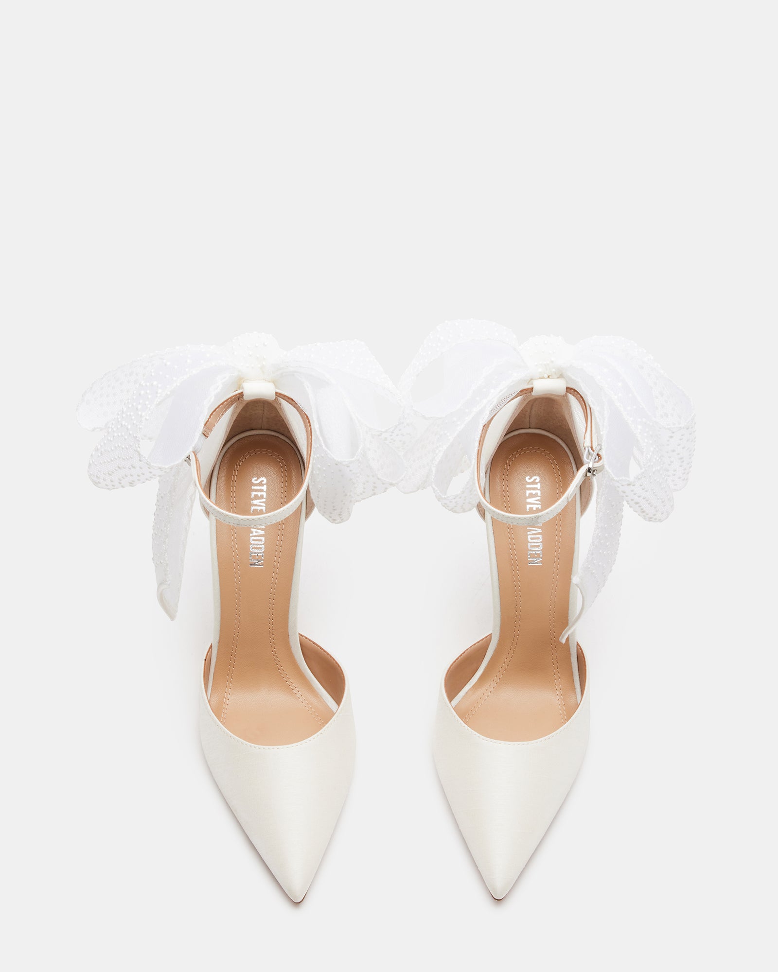 Close-up of the pearl embellishments on the satin bridal shoes.