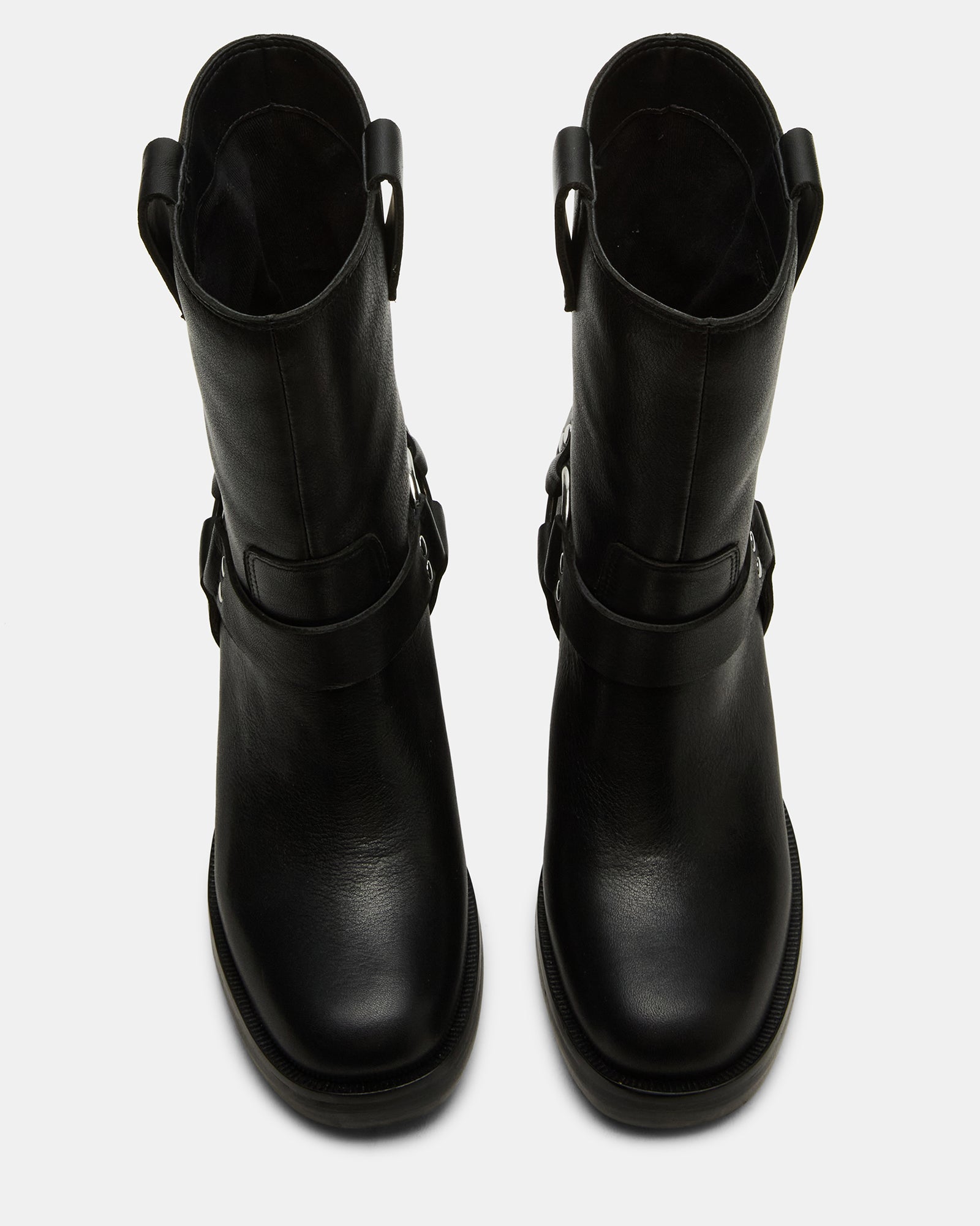 Side view of black leather Chelsea boots showcasing sleek silhouette and sturdy heel