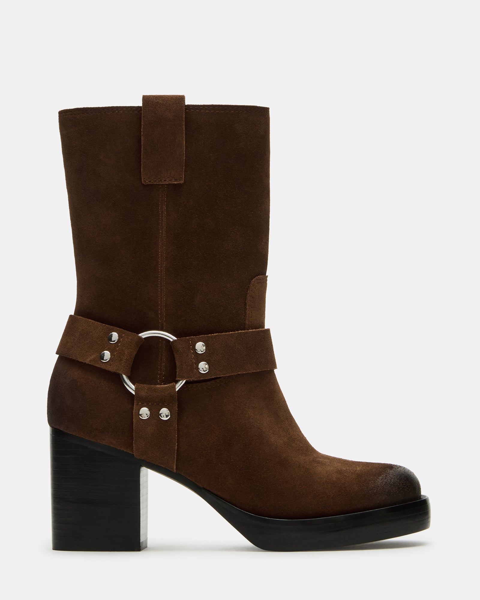 Side angle of cognac suede boots with low heel on urban pavement