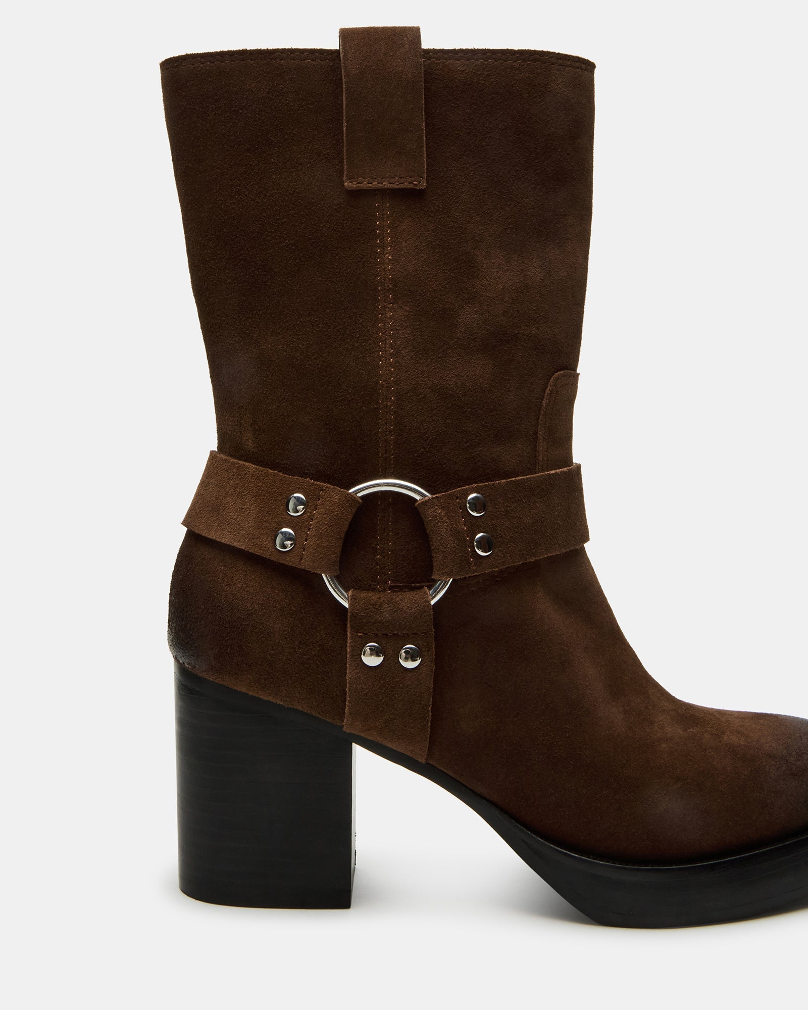 Wide ankle booties for women captured mid-stride on a sunny sidewalk
