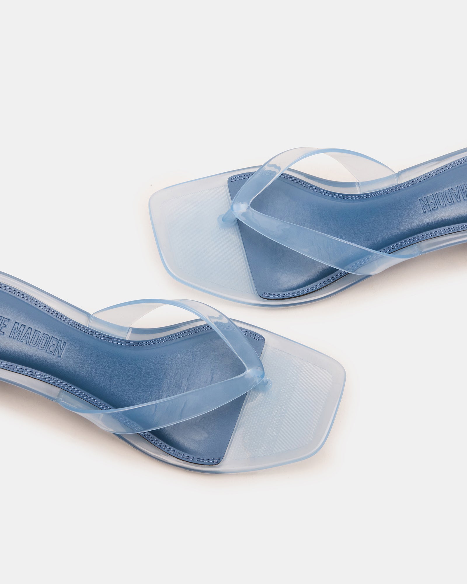 Chic light blue kitten heel sandals from the side, showcasing the square toe.