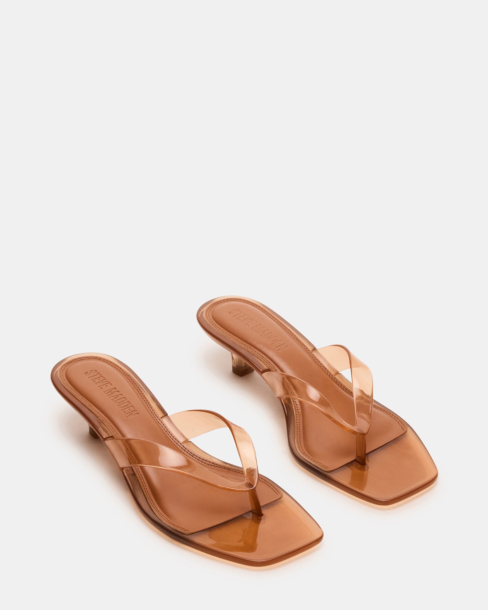 Close-up of square toe and thong strap design on these sleek black heels.