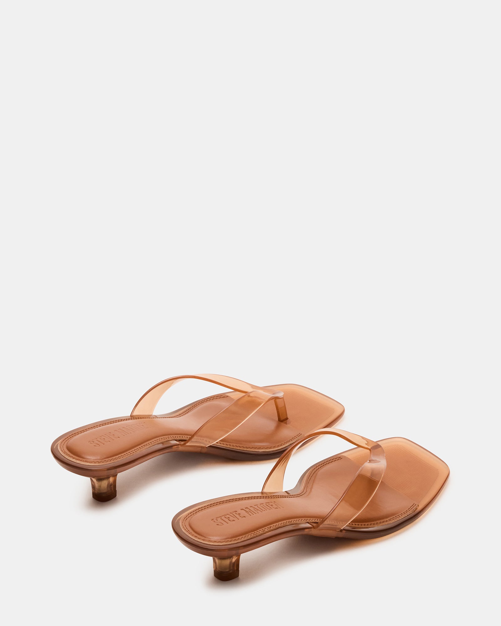 Close-up of square toe and thong strap design on these sleek black heels.