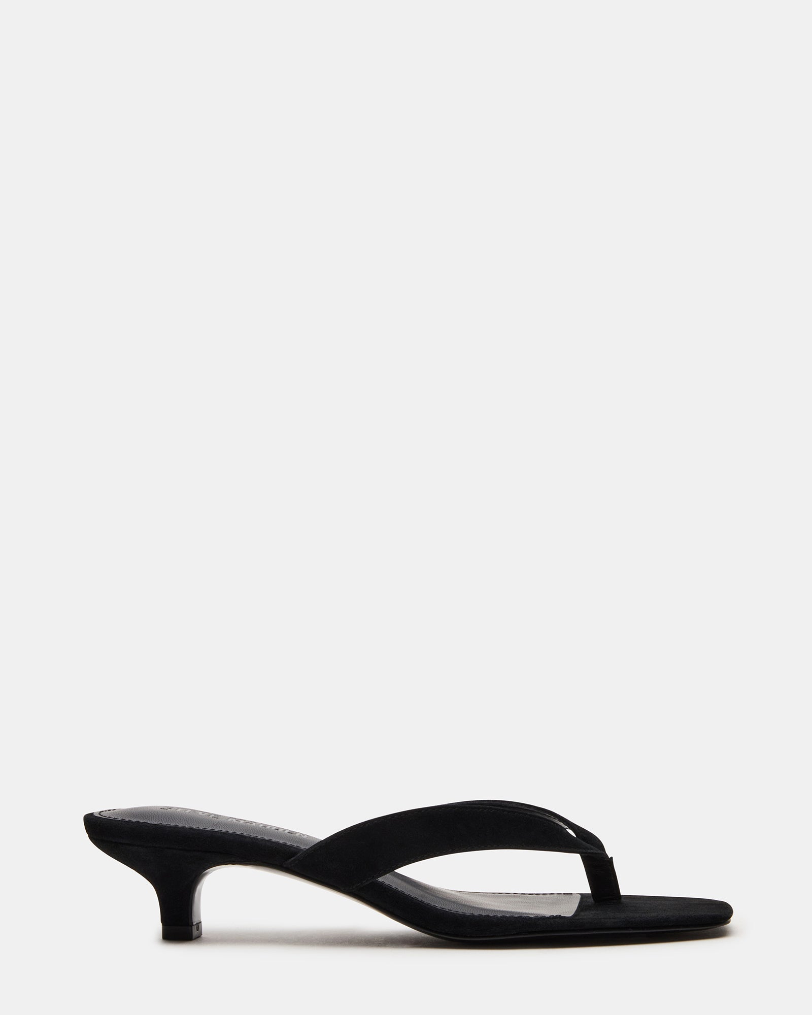 Close-up side view of black kitten heels showing sueded texture