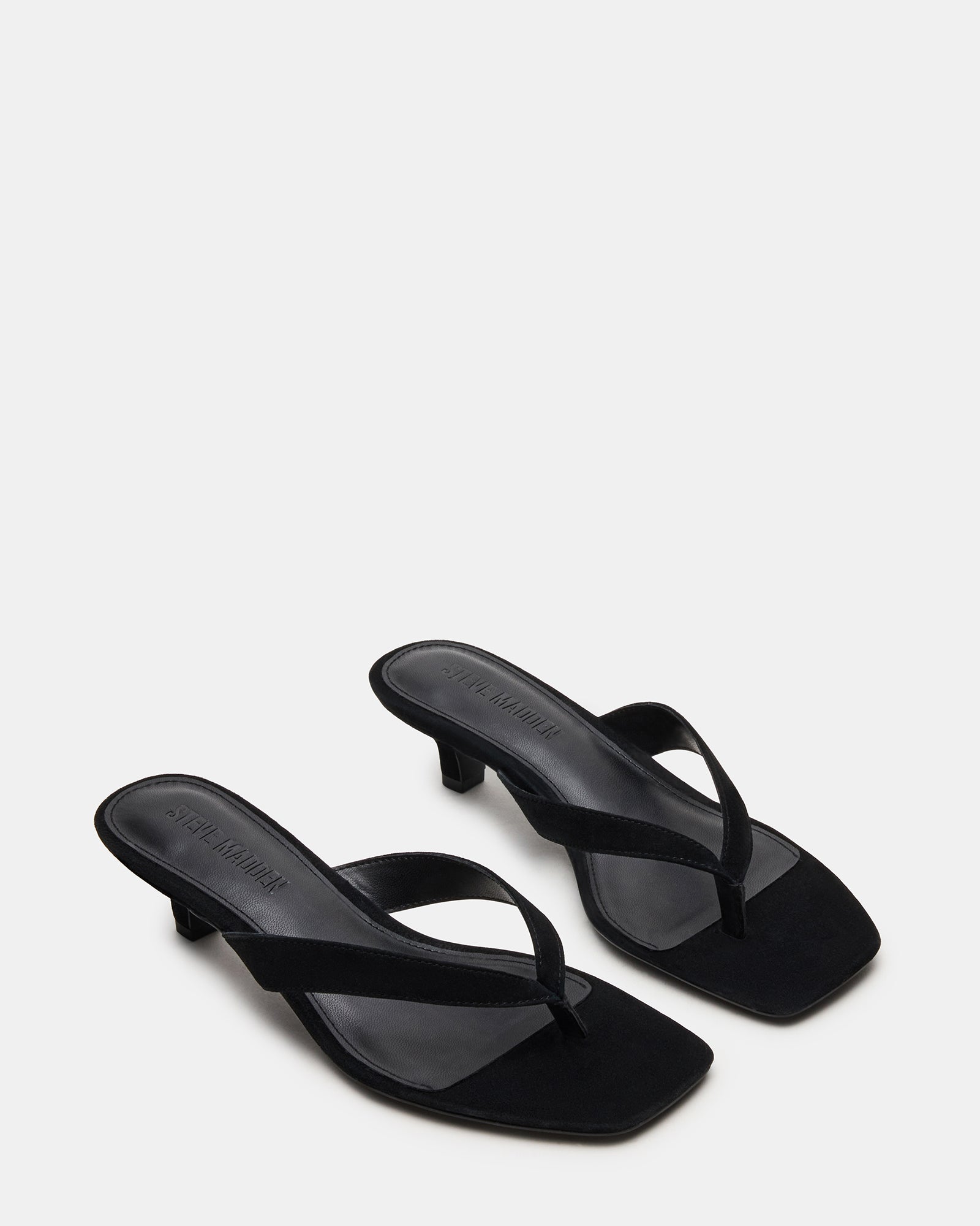 Model wearing black heels with square toe for a formal evening look