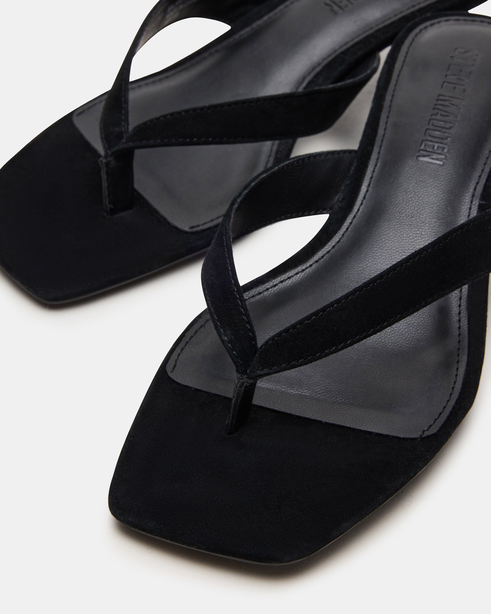Angled top view of white kitten heels beside Tracie Luxe pair for comparison