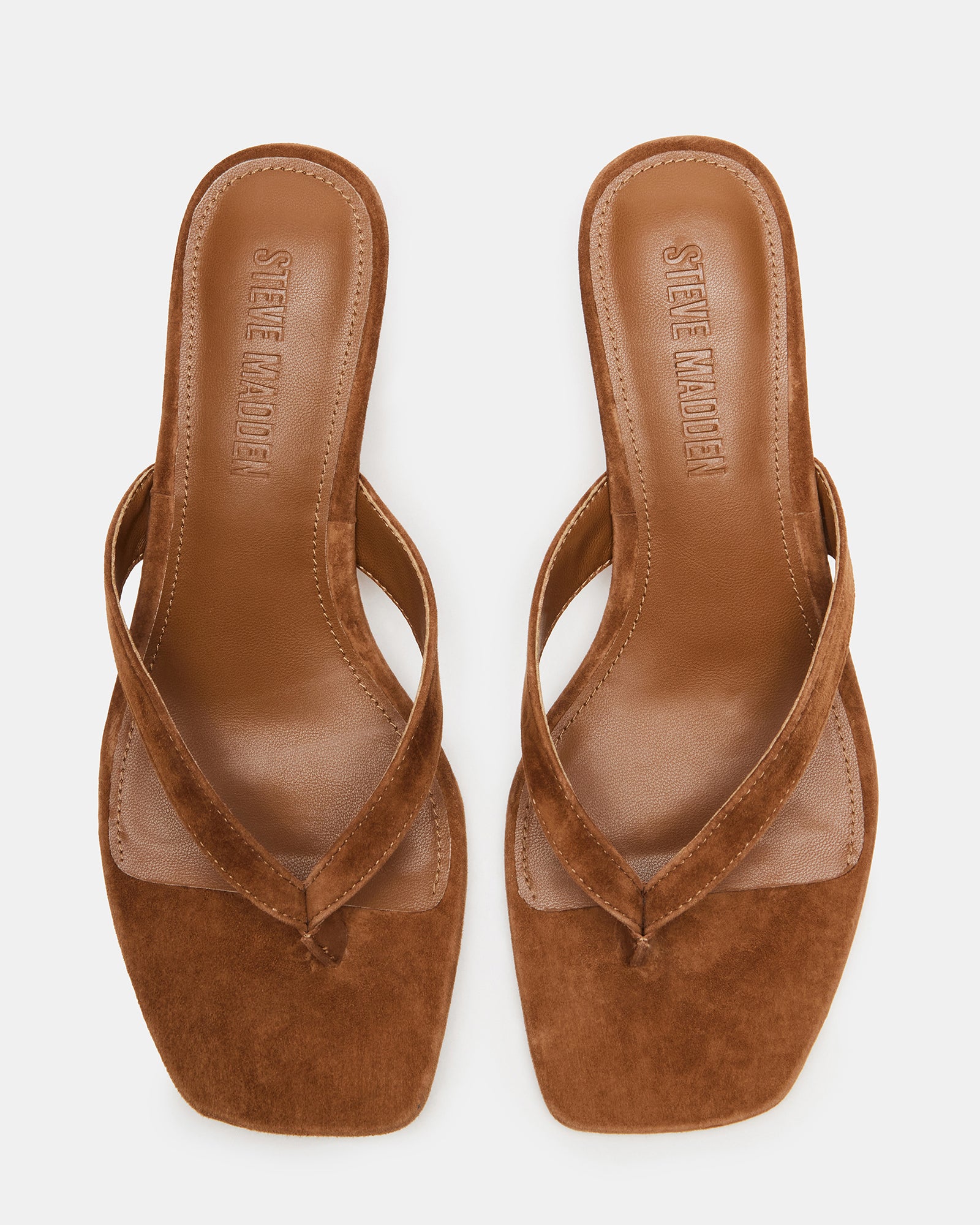 Tracie kitten heel shoes displayed on a wooden surface, highlighting the square toe design.
