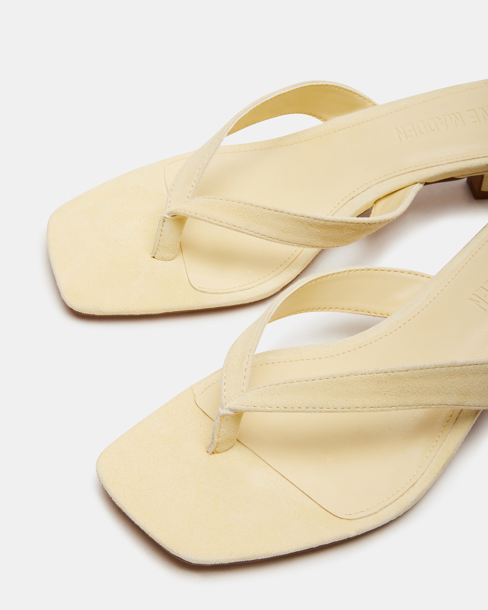 White heels showcasing the suede texture and 2-inch heel