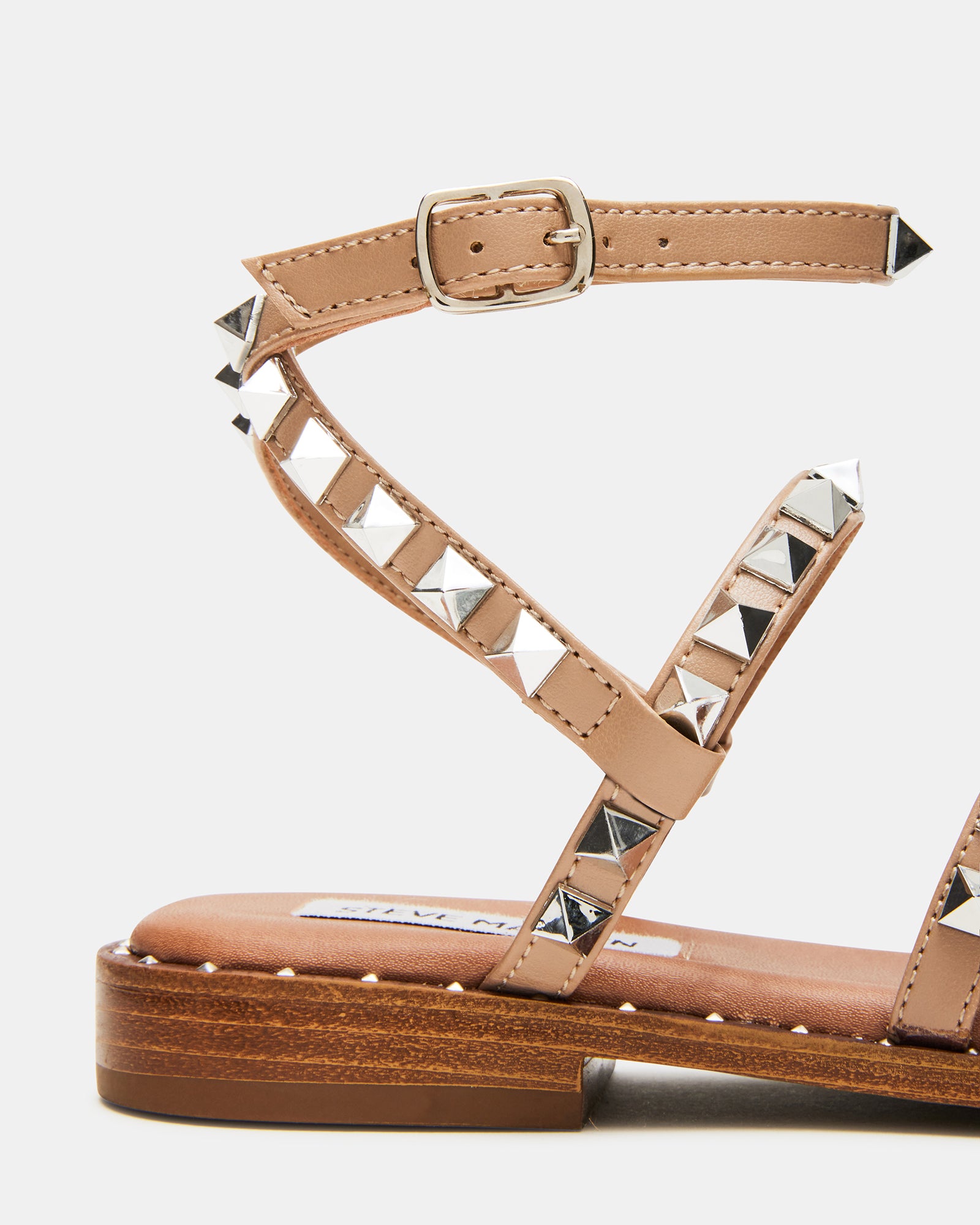 Close-up of the heel and straps of stylish vegan footwear with hardware accents