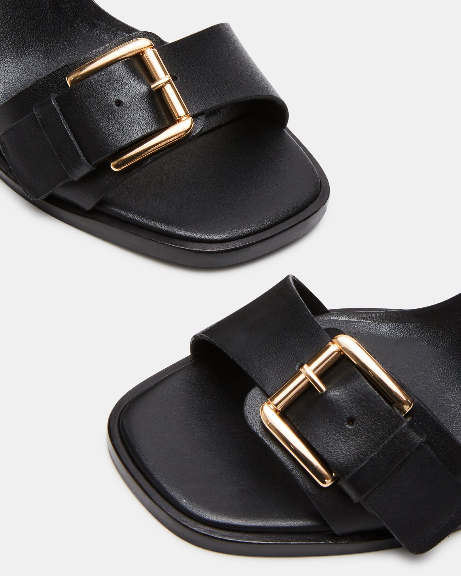 Side view of black block heel sandals showcasing the square toe design.