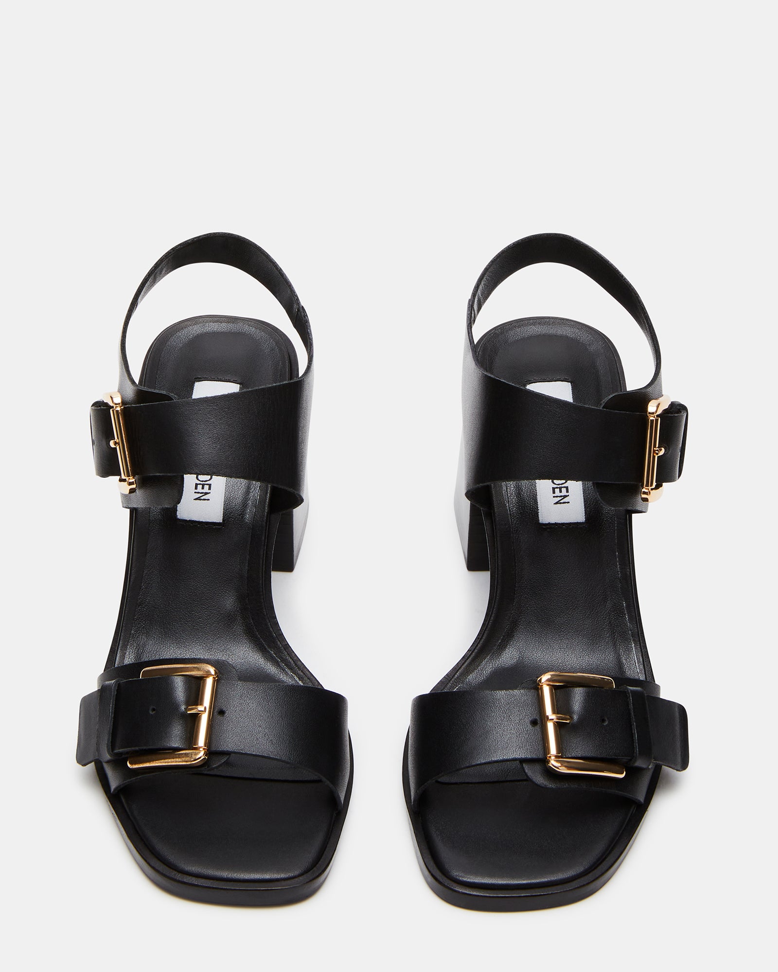 Close-up of buckle hardware on black leather sandals.
