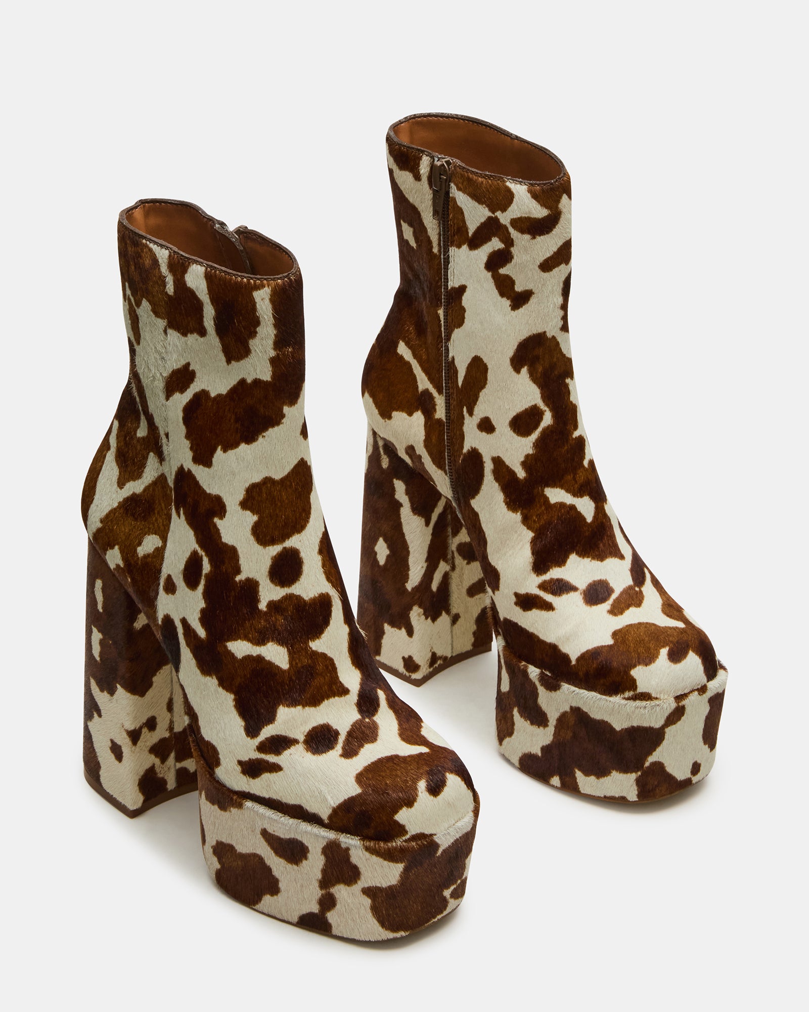 Close-up of square-toe design and cow print pattern on ankle boot