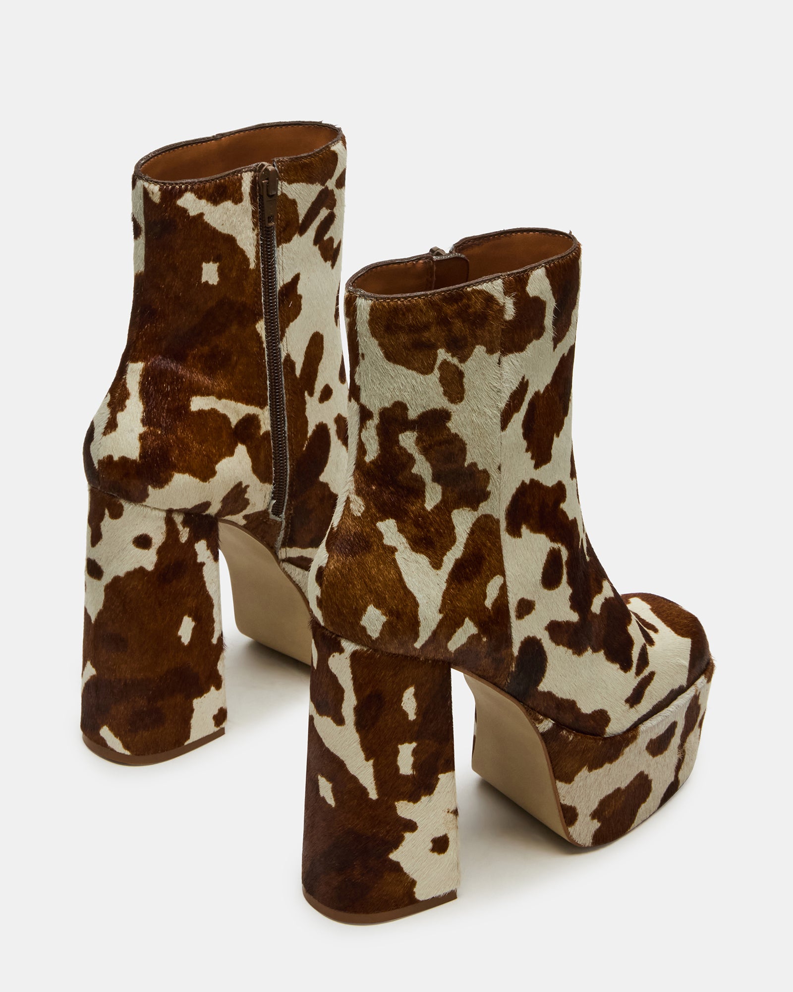 Close-up of square-toe design and cow print pattern on ankle boot