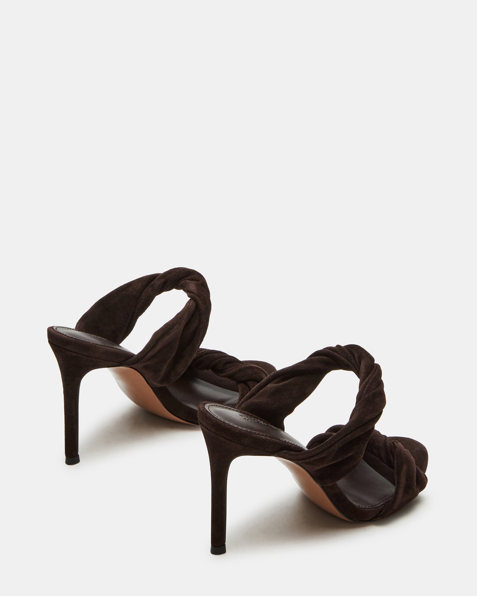 Side view of brown suede mule heels showcasing the chic silhouette and heel height.