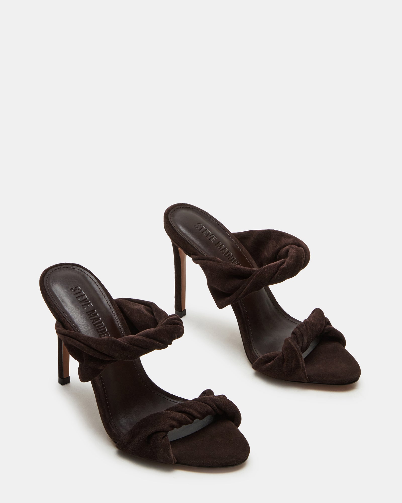 Side view of brown suede mule heels showcasing the chic silhouette and heel height.