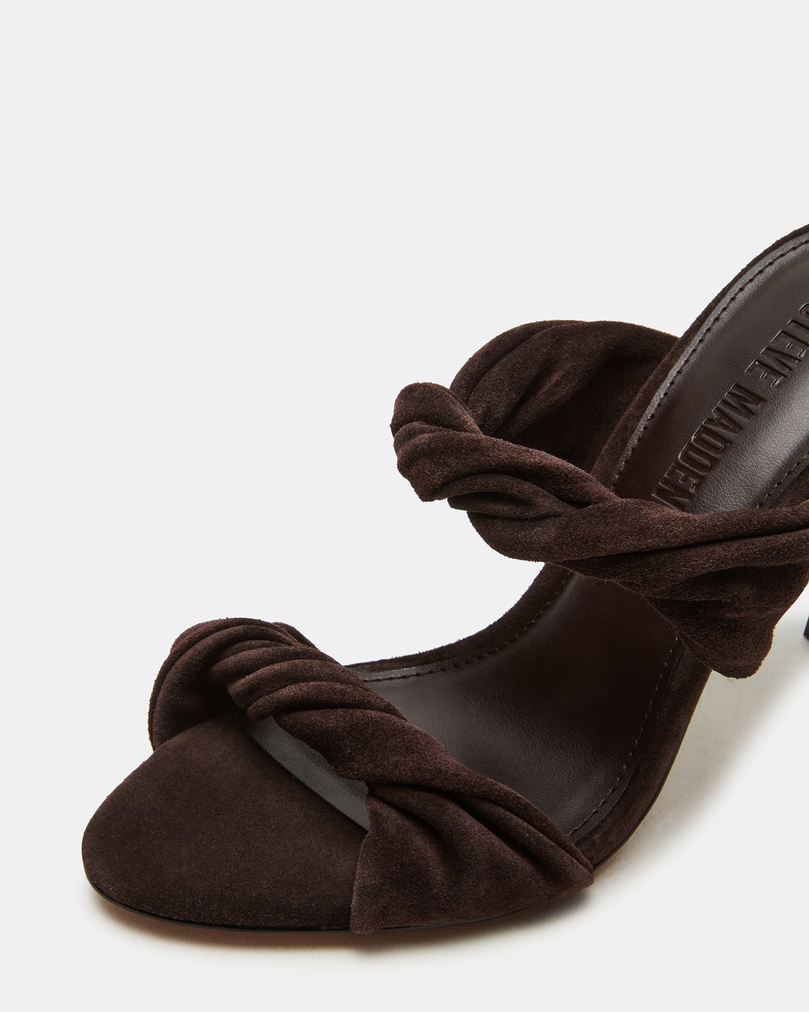 Brown suede mule shoes heels styled with a fashionable outfit for a night out.