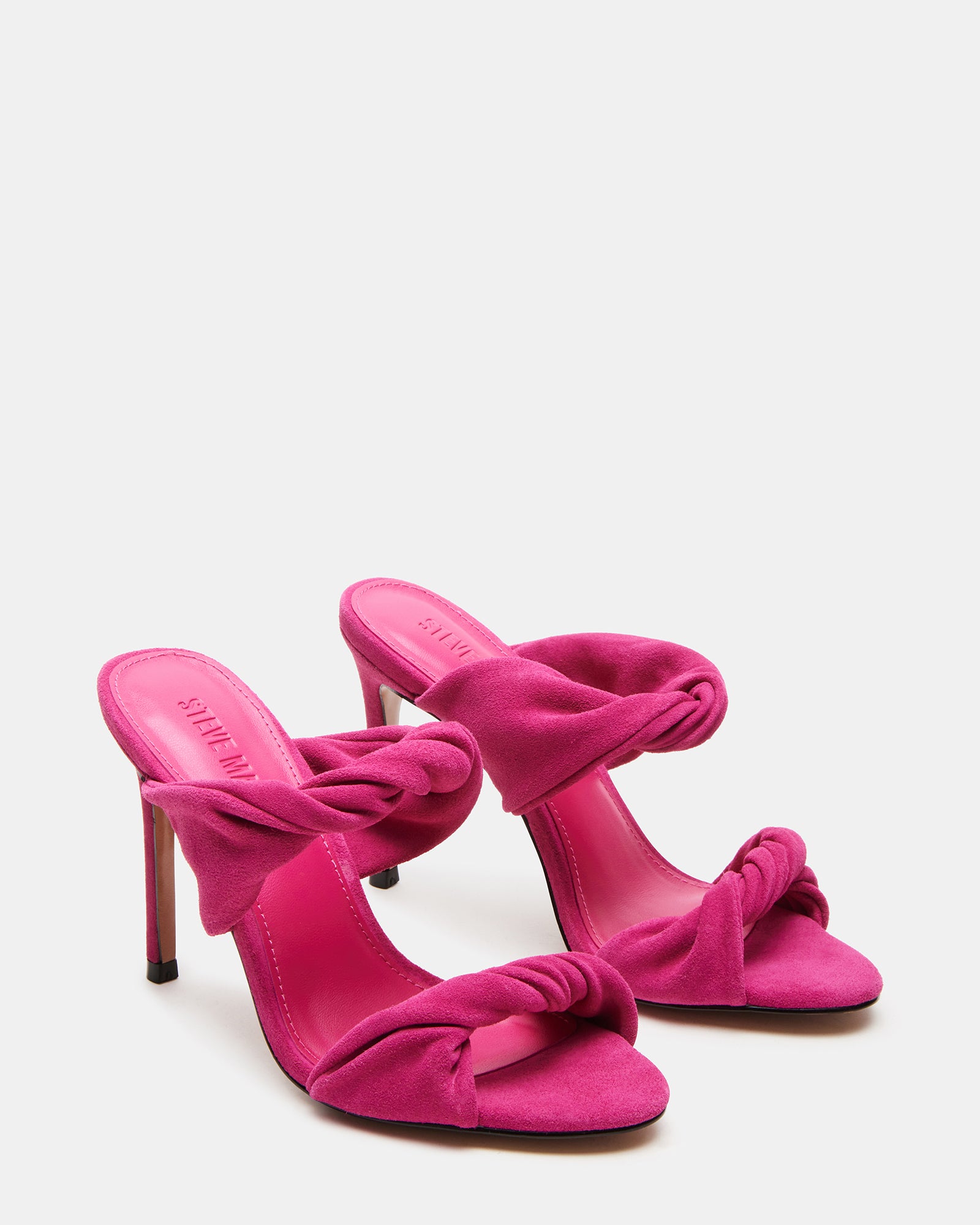 Angled shot showing black mule heels with soft suede texture