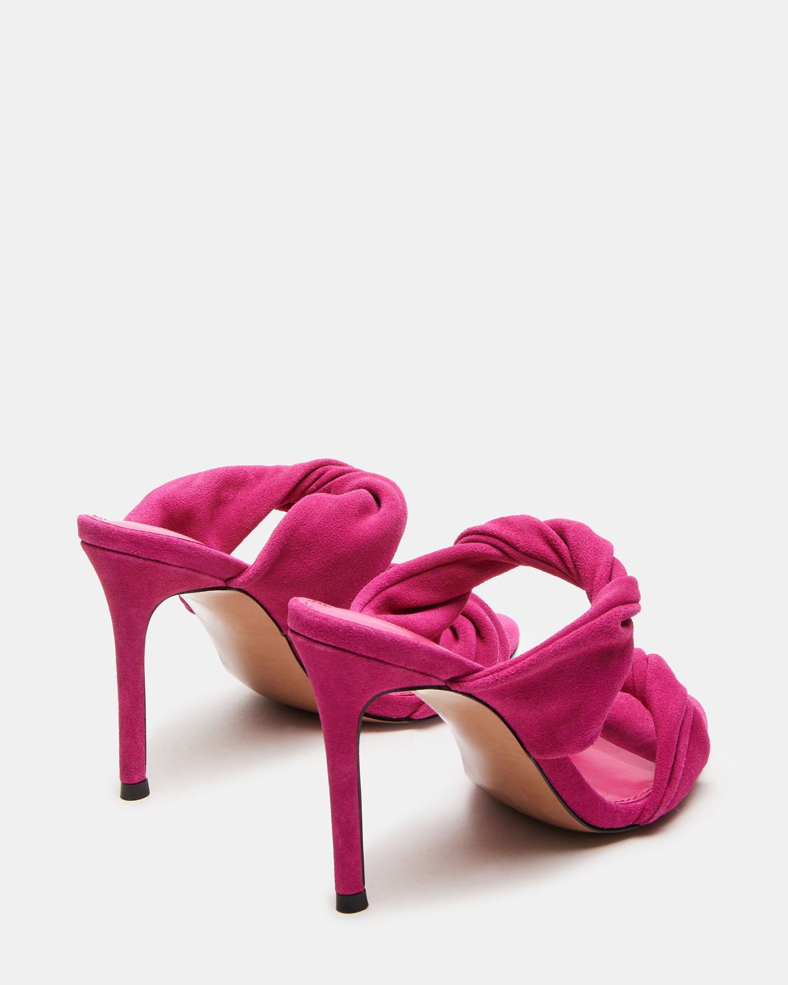 Angled shot showing black mule heels with soft suede texture