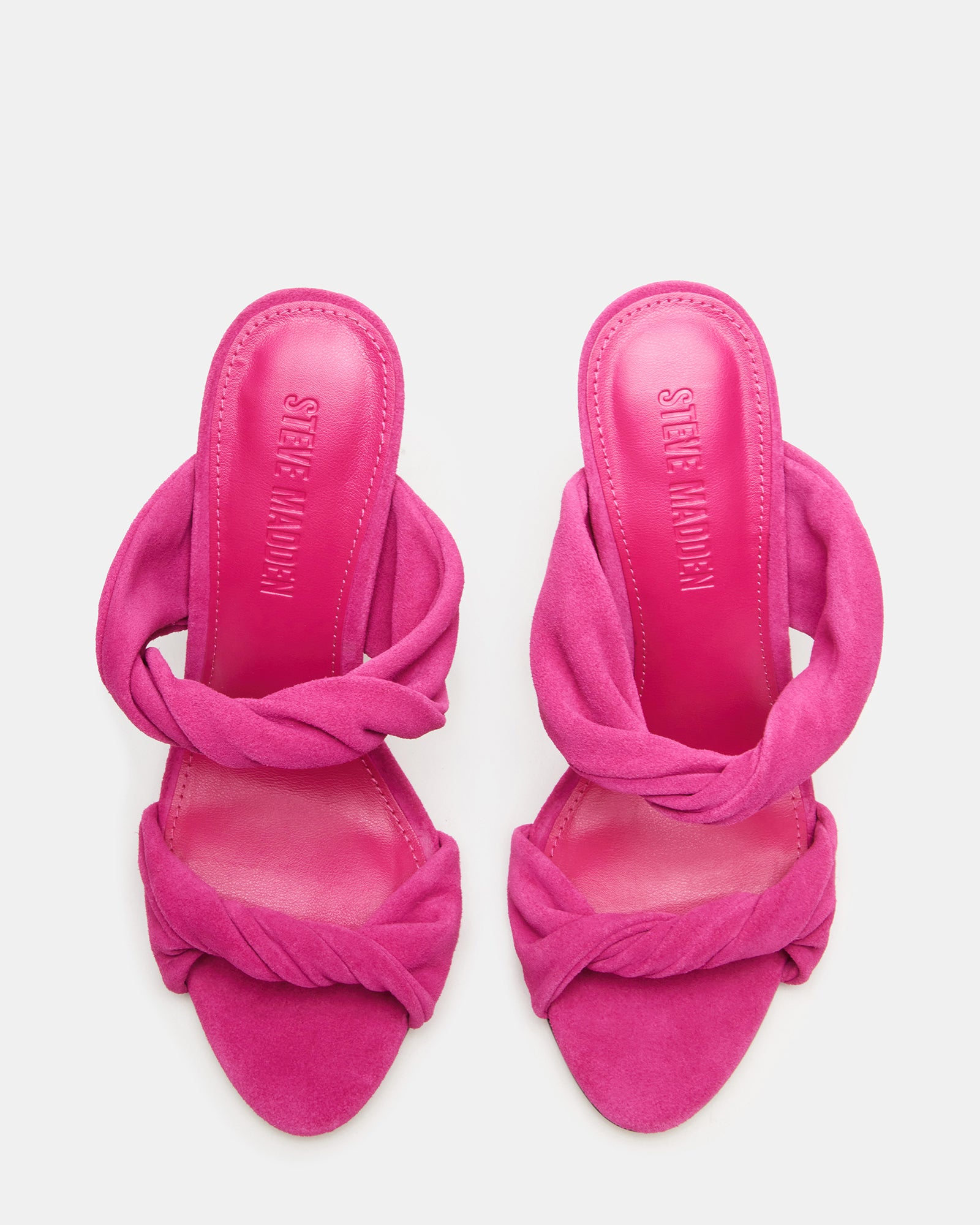 Side view of fuchsia suede stiletto heels with mule silhouette