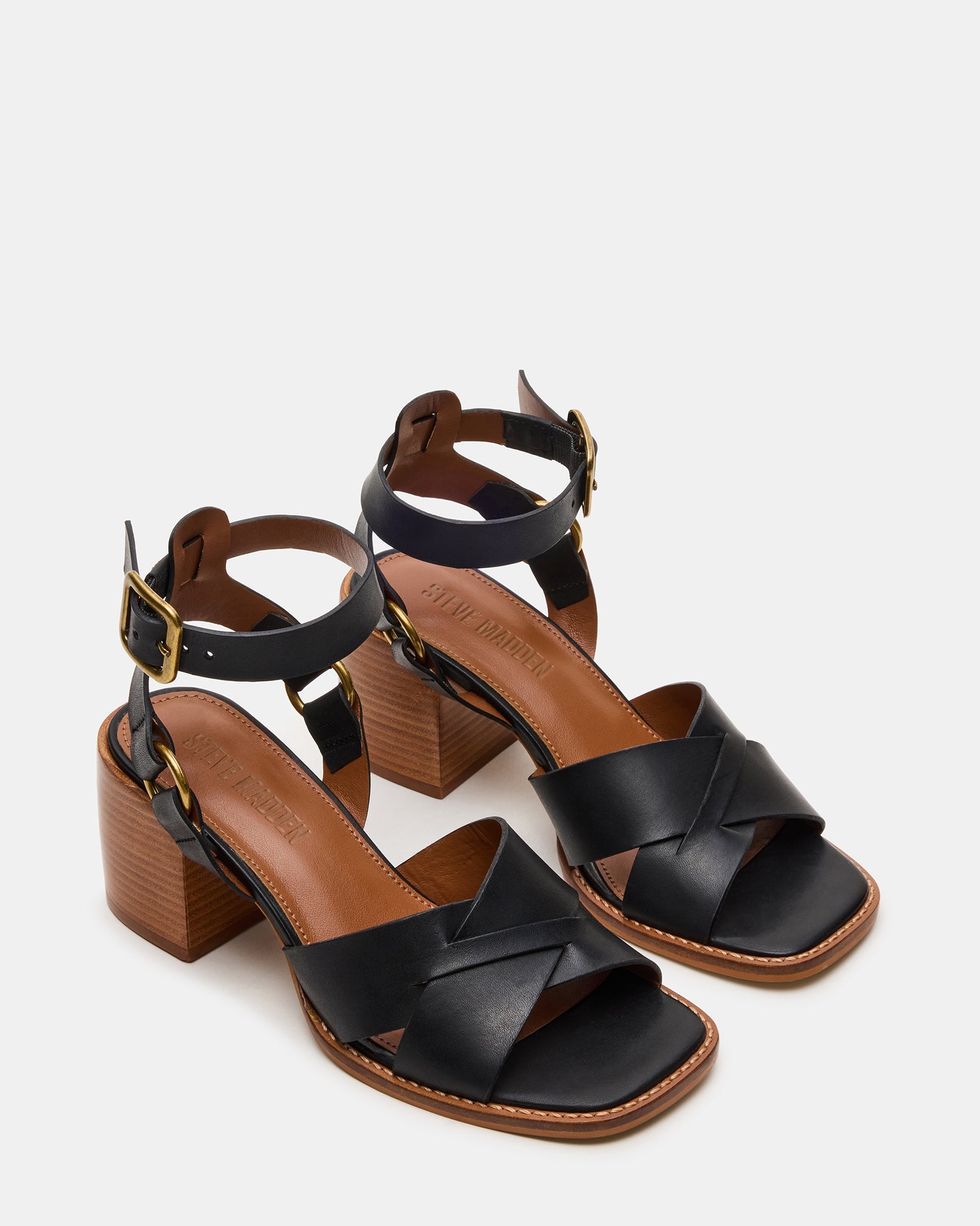 Close-up of strappy block heel sandals showing wood-textured heel and buckle