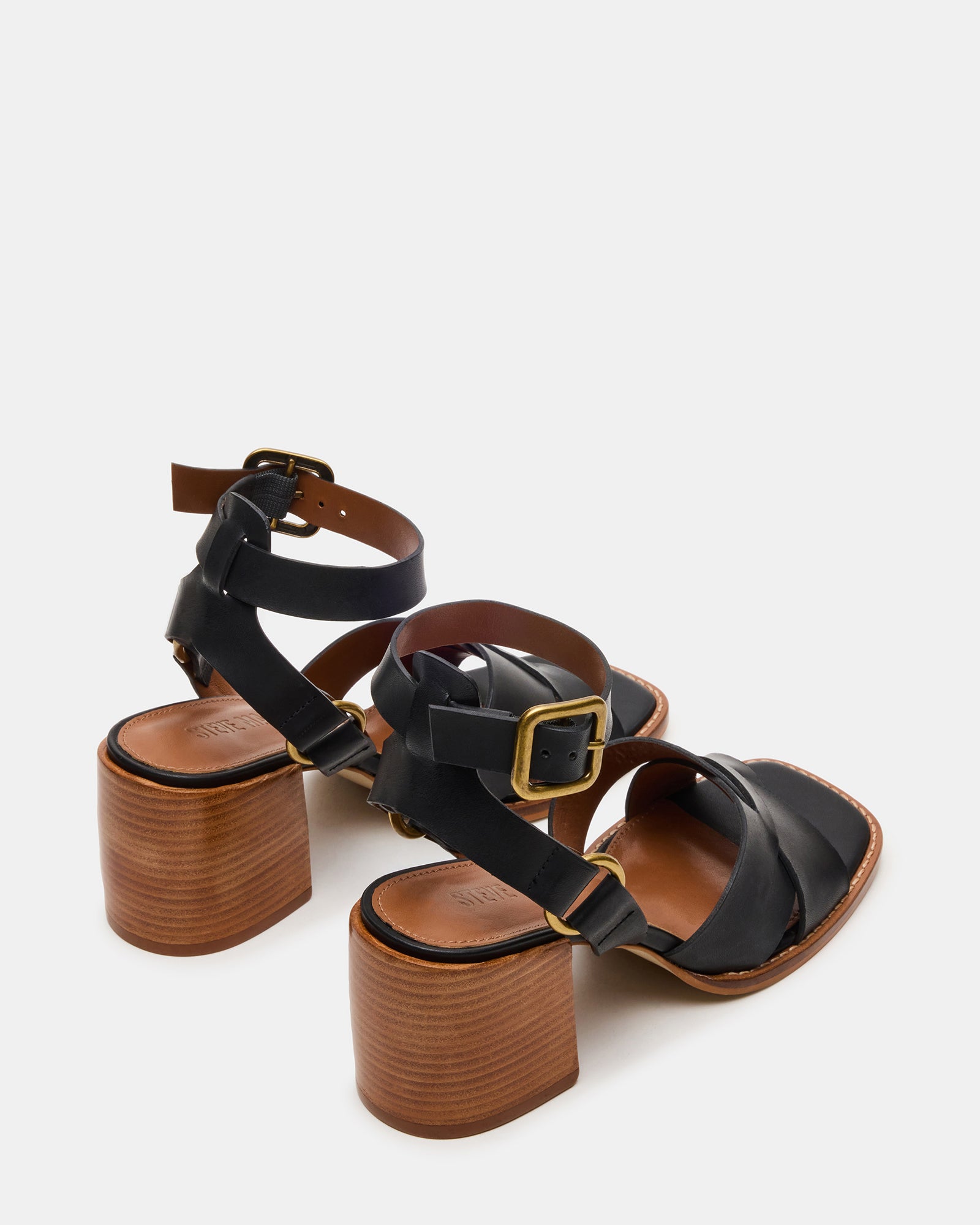 Close-up of strappy block heel sandals showing wood-textured heel and buckle