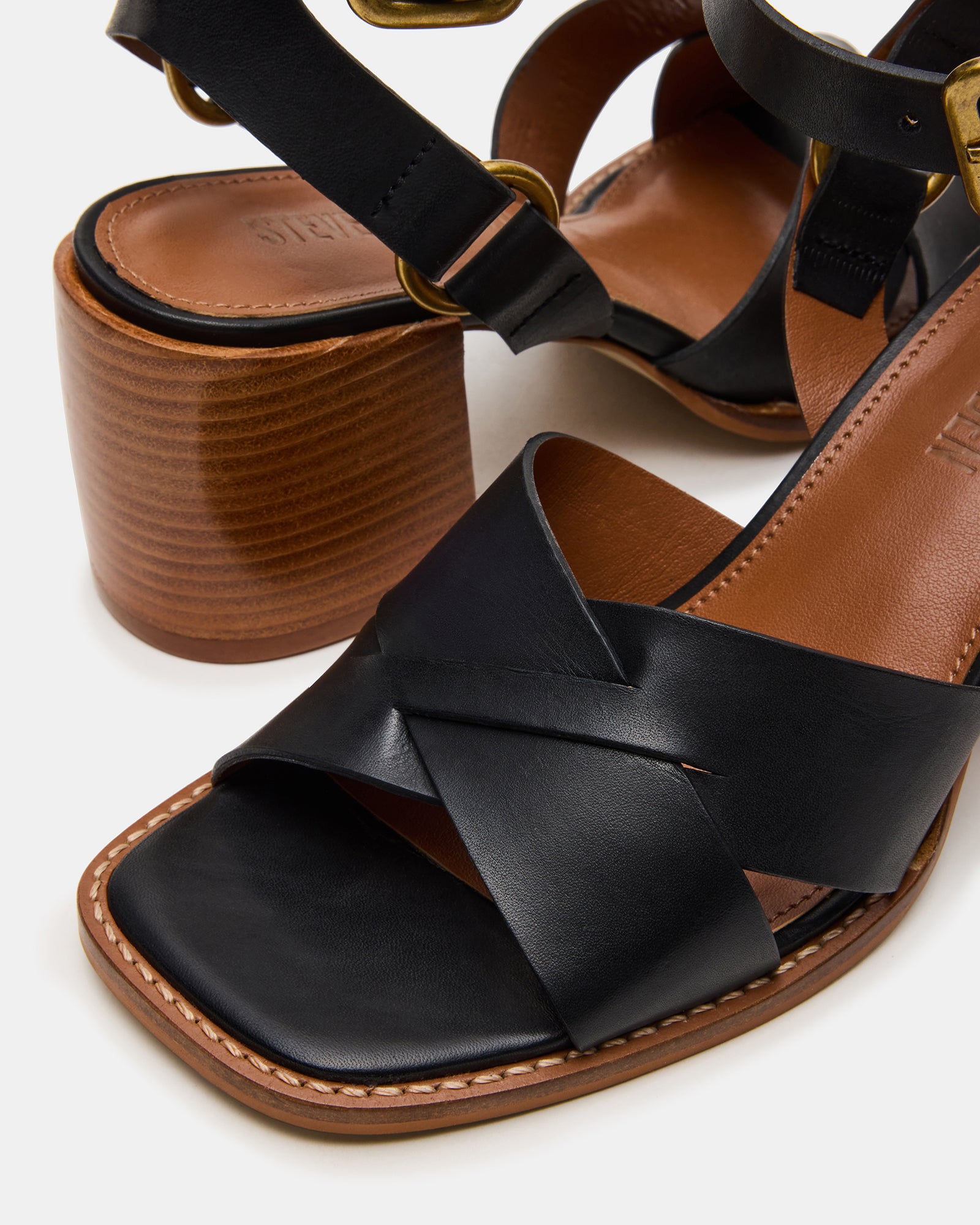 Black patent leather heels styled with a formal outfit for evening wear