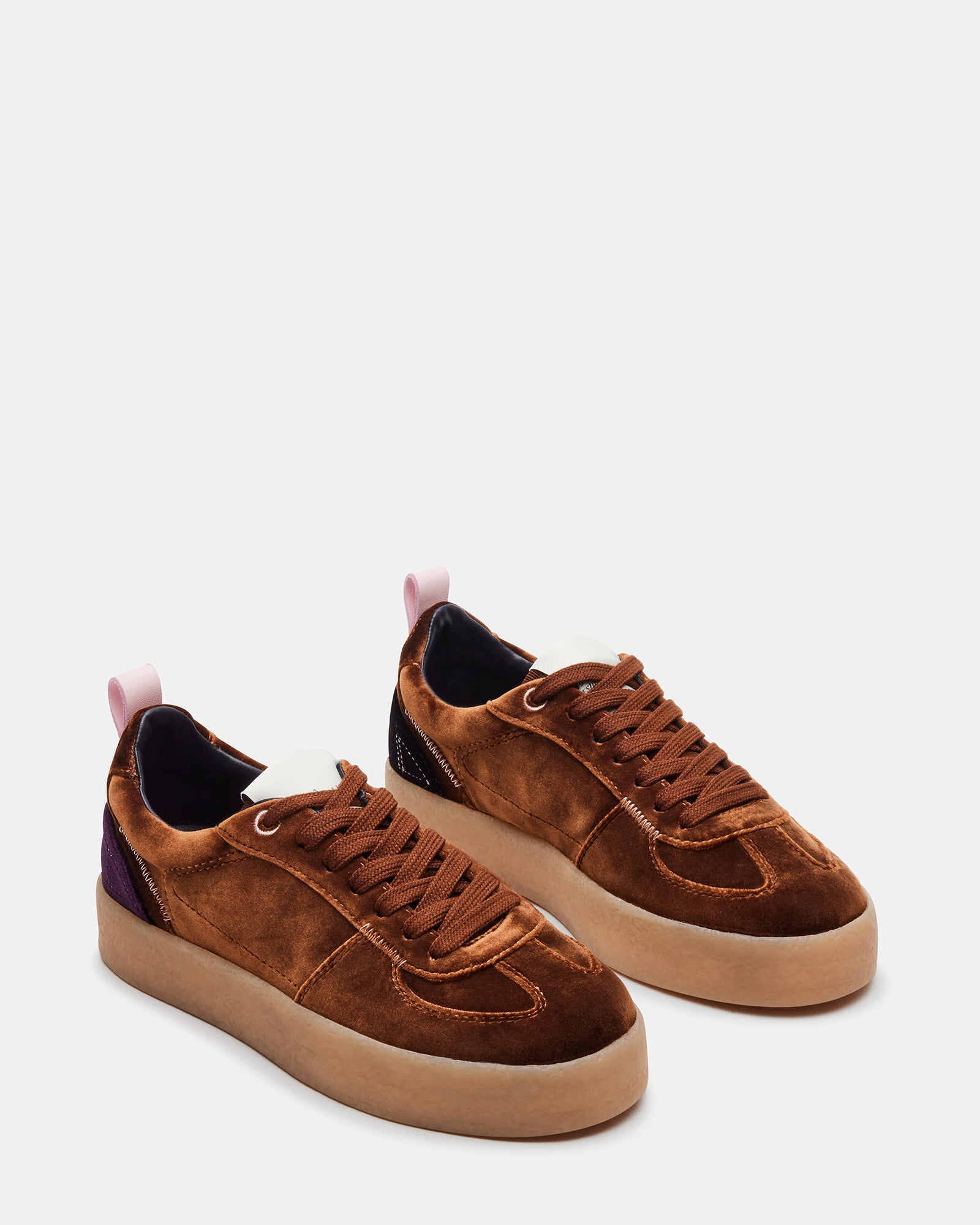 Tucker Brown Multi platform sneakers worn with casual attire in a park.