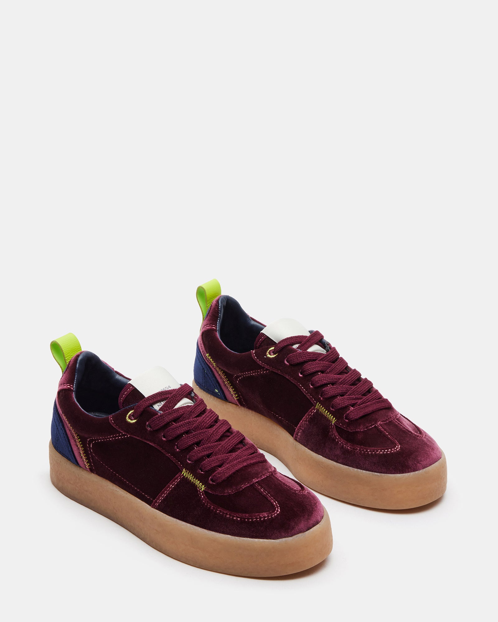 Burgundy Tucker platform sneakers on display showcasing heel height.