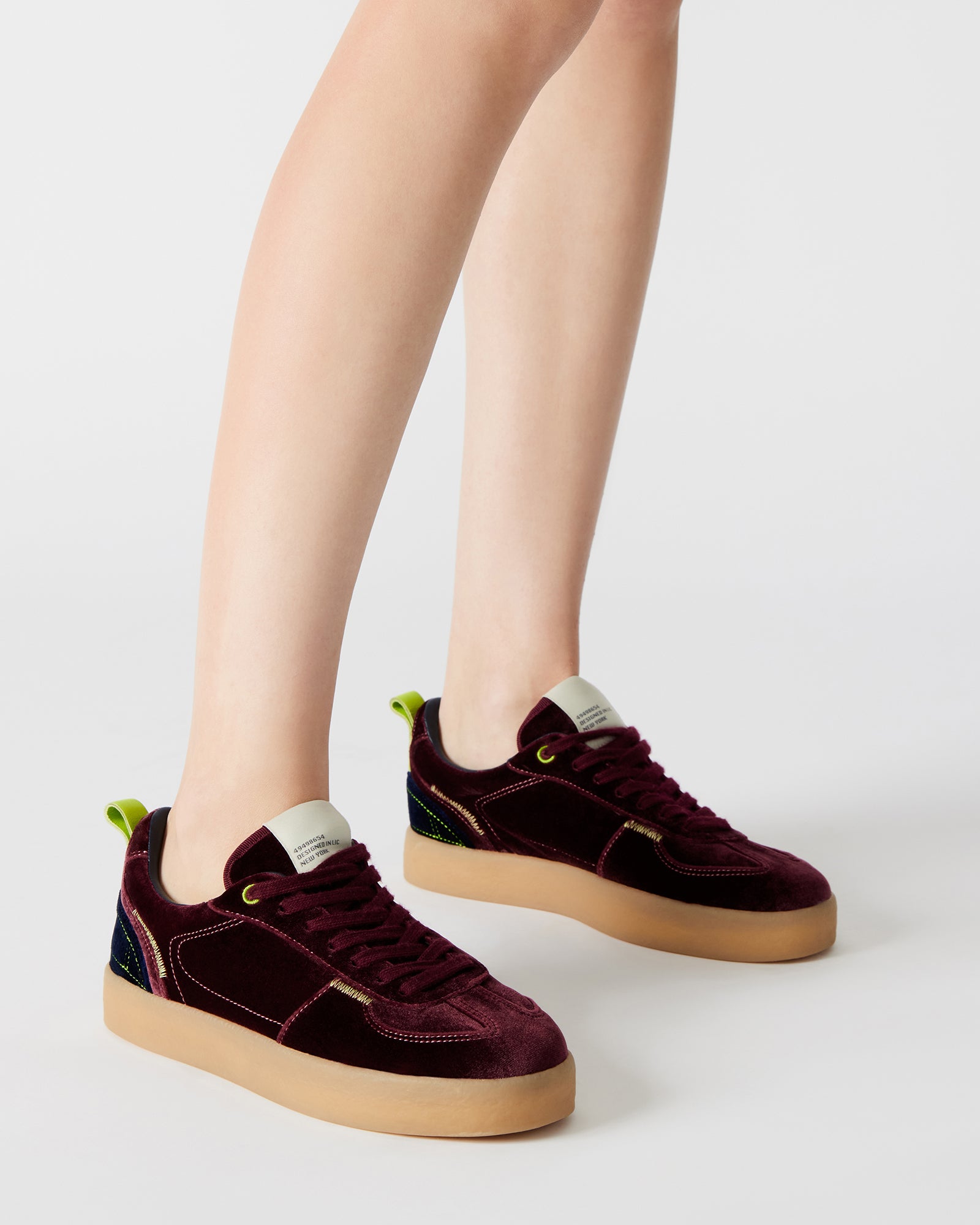 Burgundy Tucker platform sneakers styled with casual outfit.