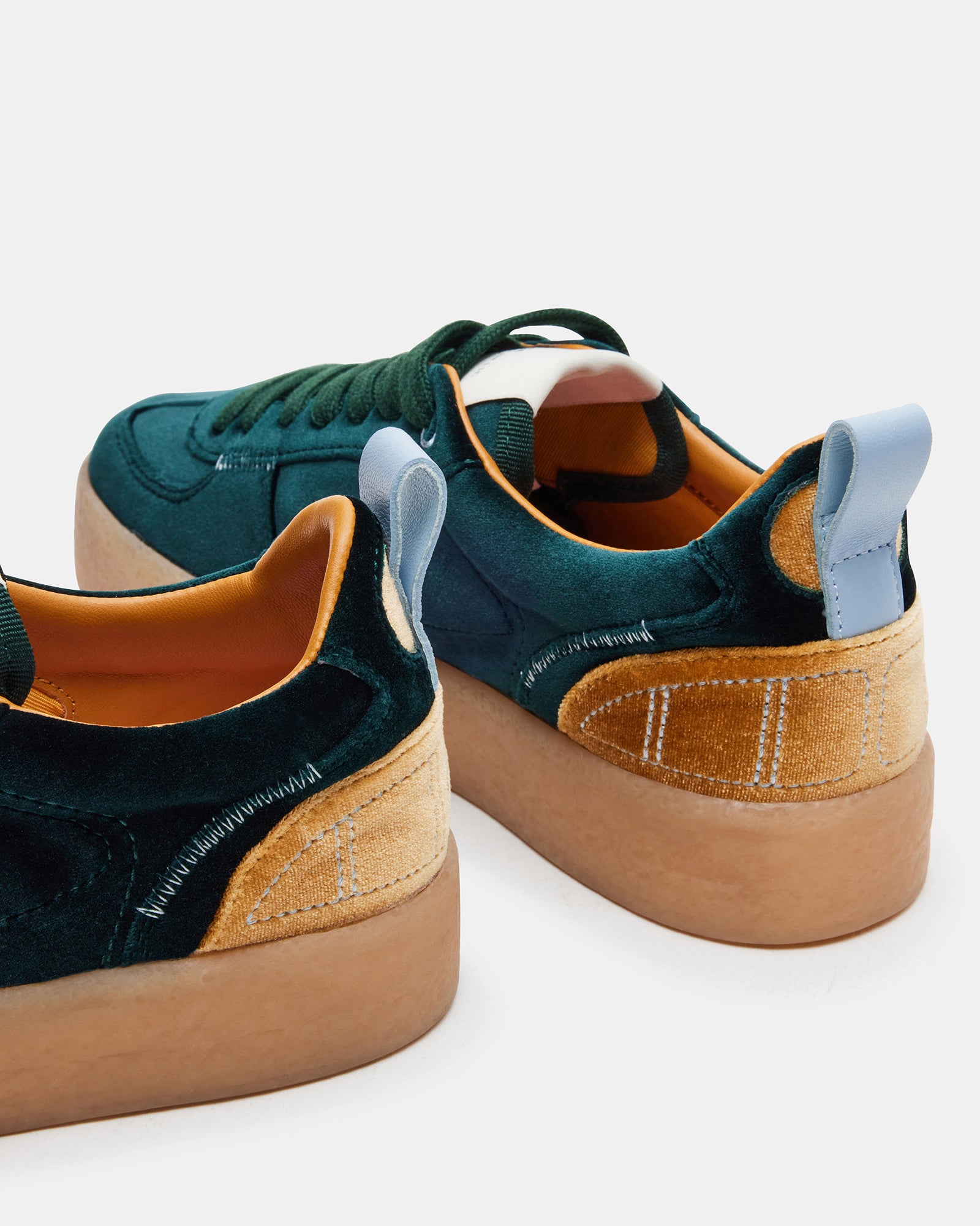 Side view of Tucker Green Multi platform sneakers on a city street