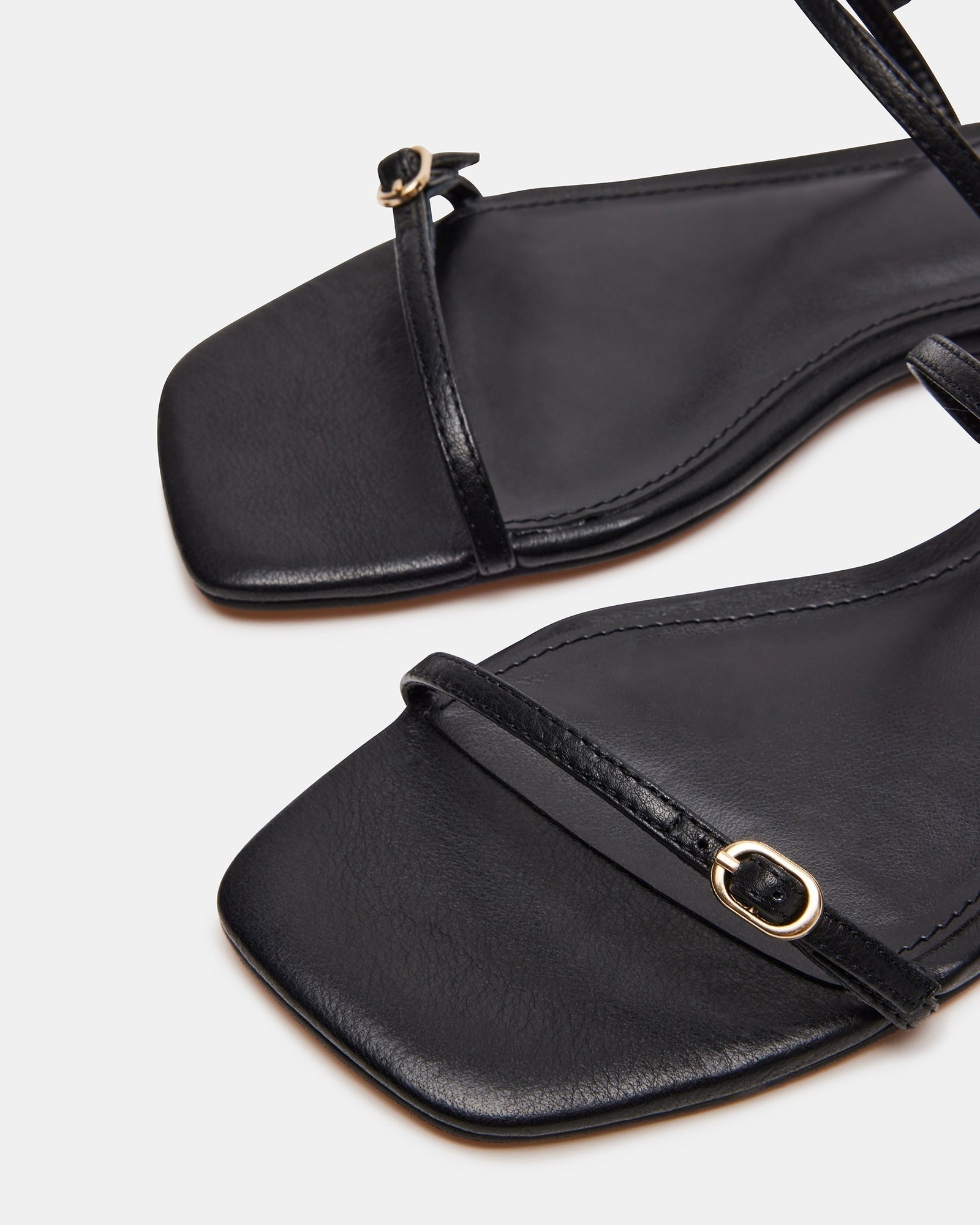 Close-up of brown leather sandal texture and heel design for women