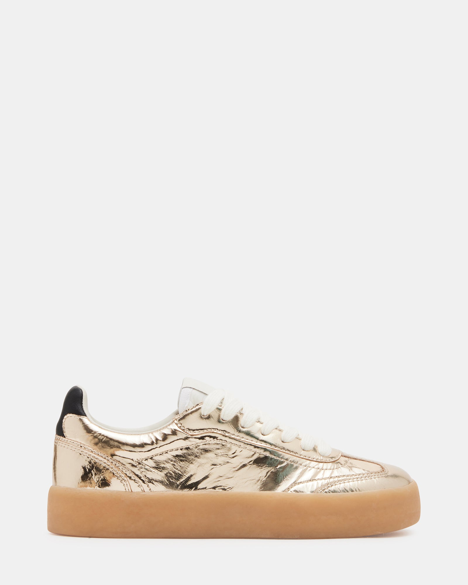 Side view of TUX Gold low-top sneakers showing sleek leather finish and gold details