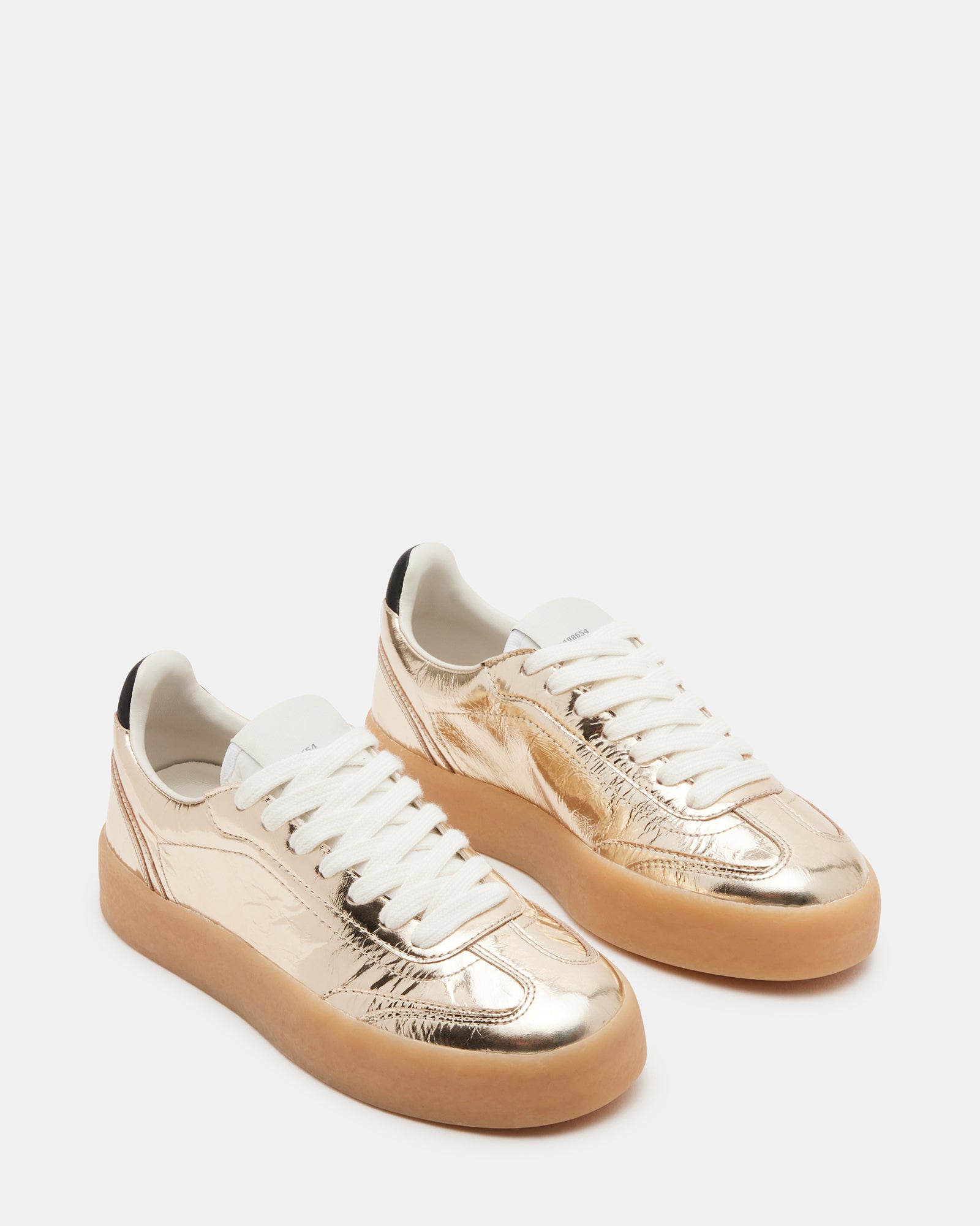 TUX Gold sneakers styled with casual jeans, perfect for urban outings