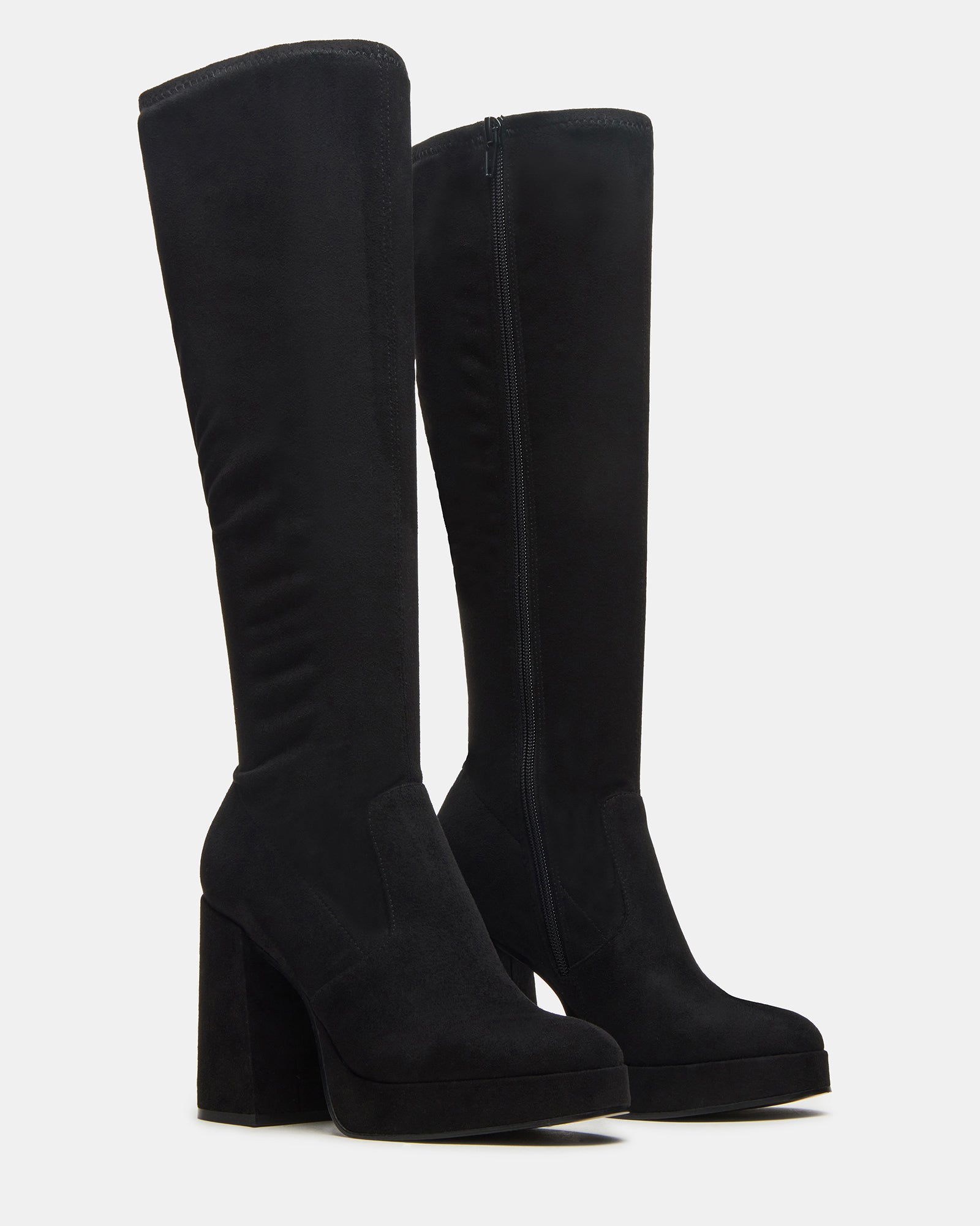 Black knee-high boots worn with a stylish outfit for a night out.