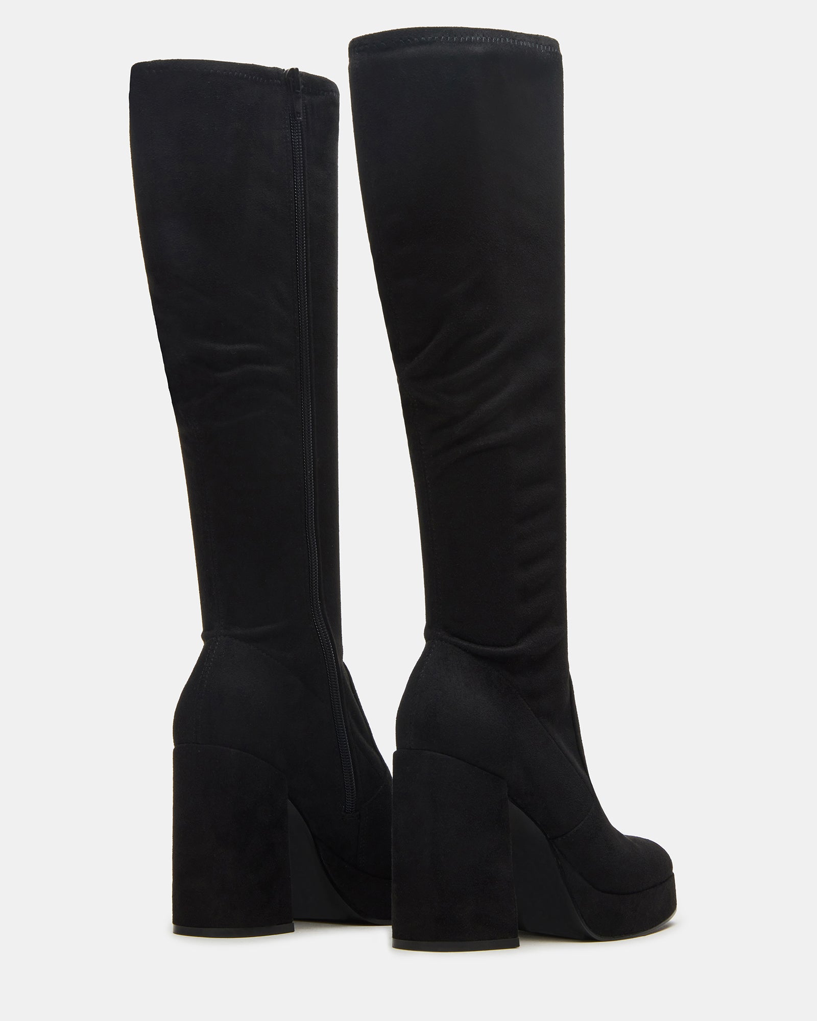 Black knee-high boots worn with a stylish outfit for a night out.
