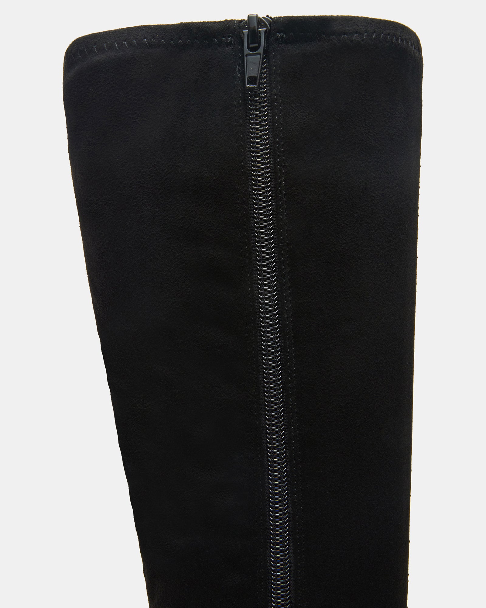 Close-up of the inside zipper on black leather knee-high boots.