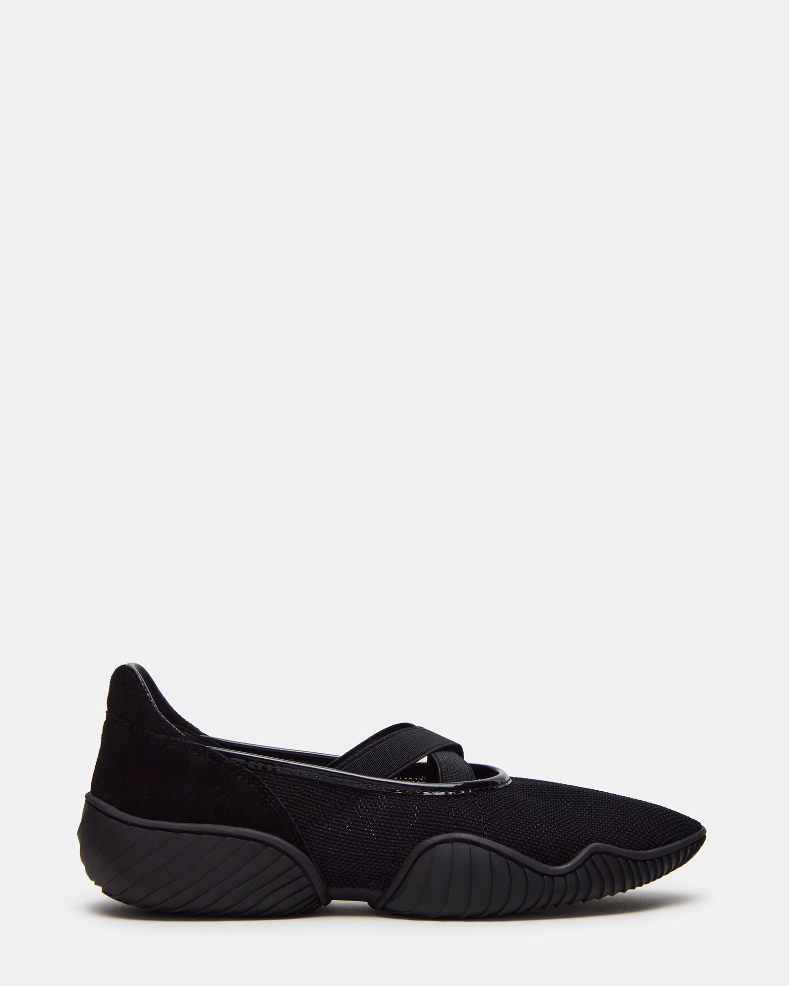 Side view of black low-top mesh sneakers on Boston pavement