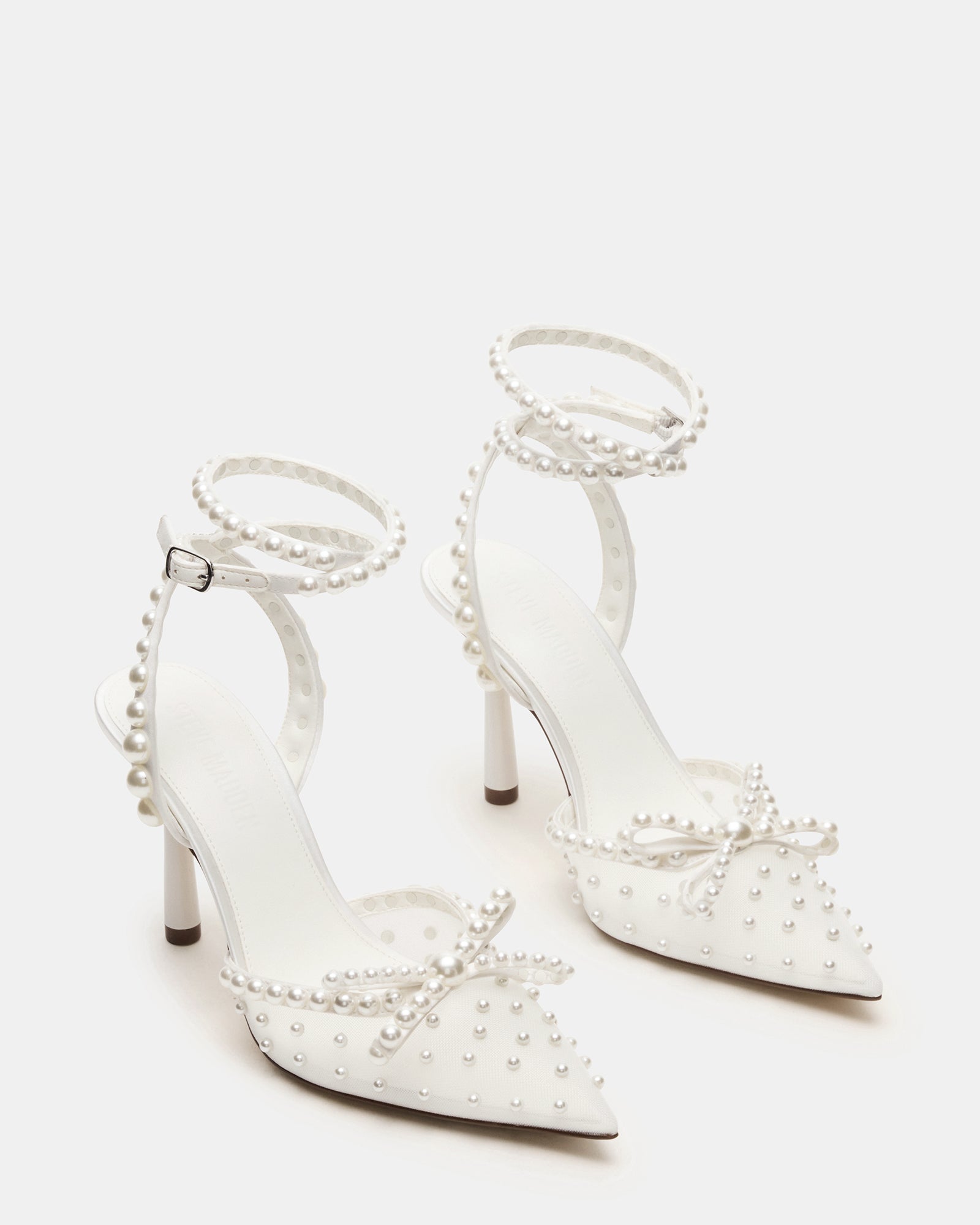 Fashionable pair of ivory heels with elegant embellishments for special occasions