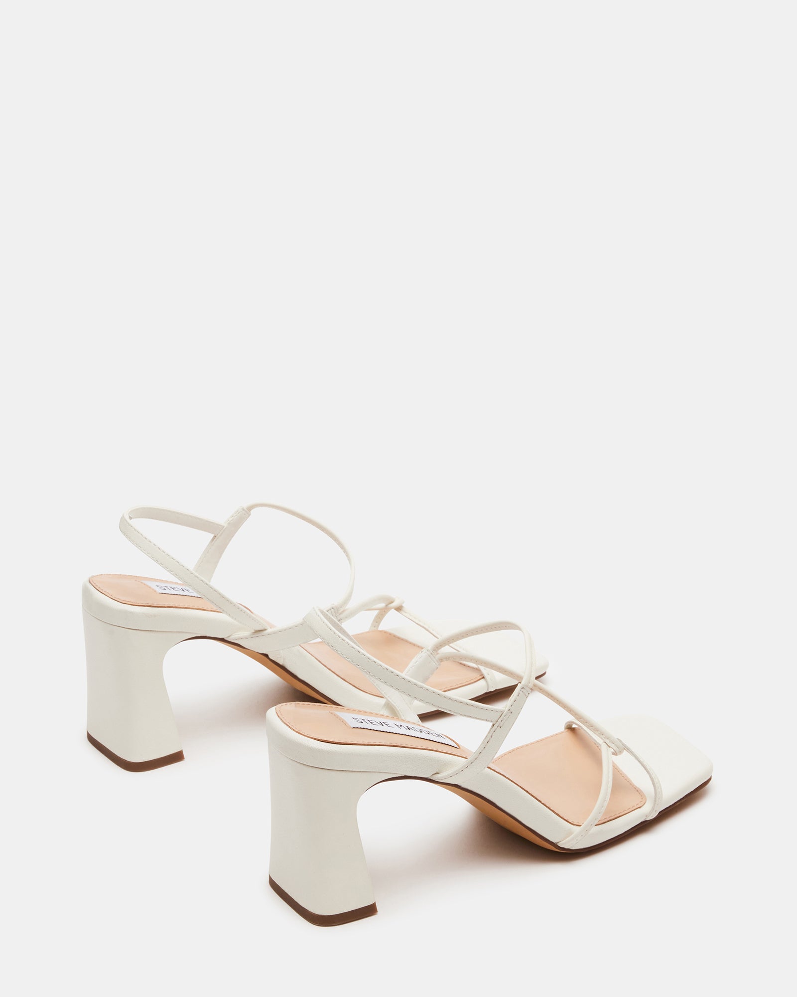 Close-up of Valora white leather heels highlighting the material.