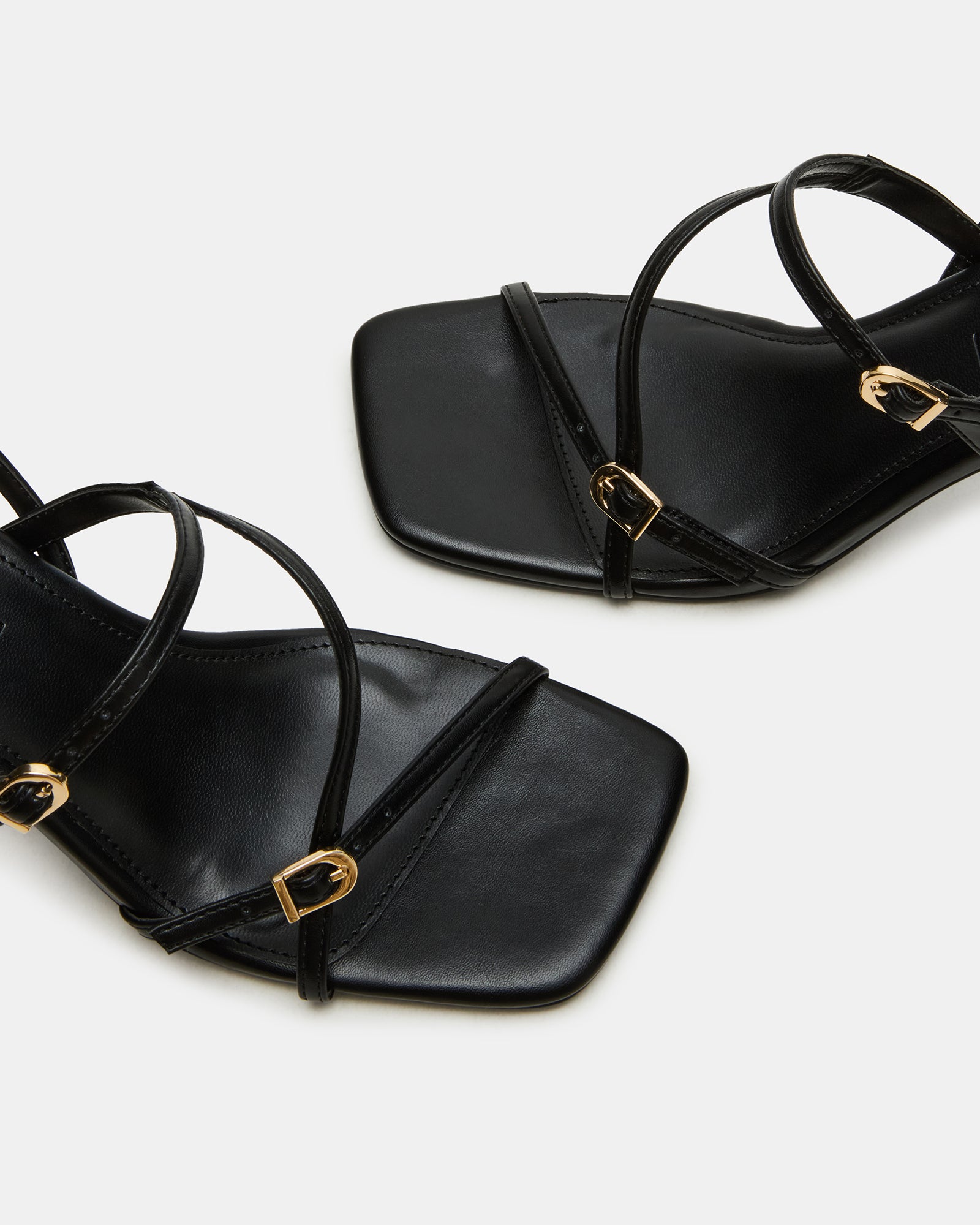 Elegant black slingback kitten heels showcasing stylish buckles.