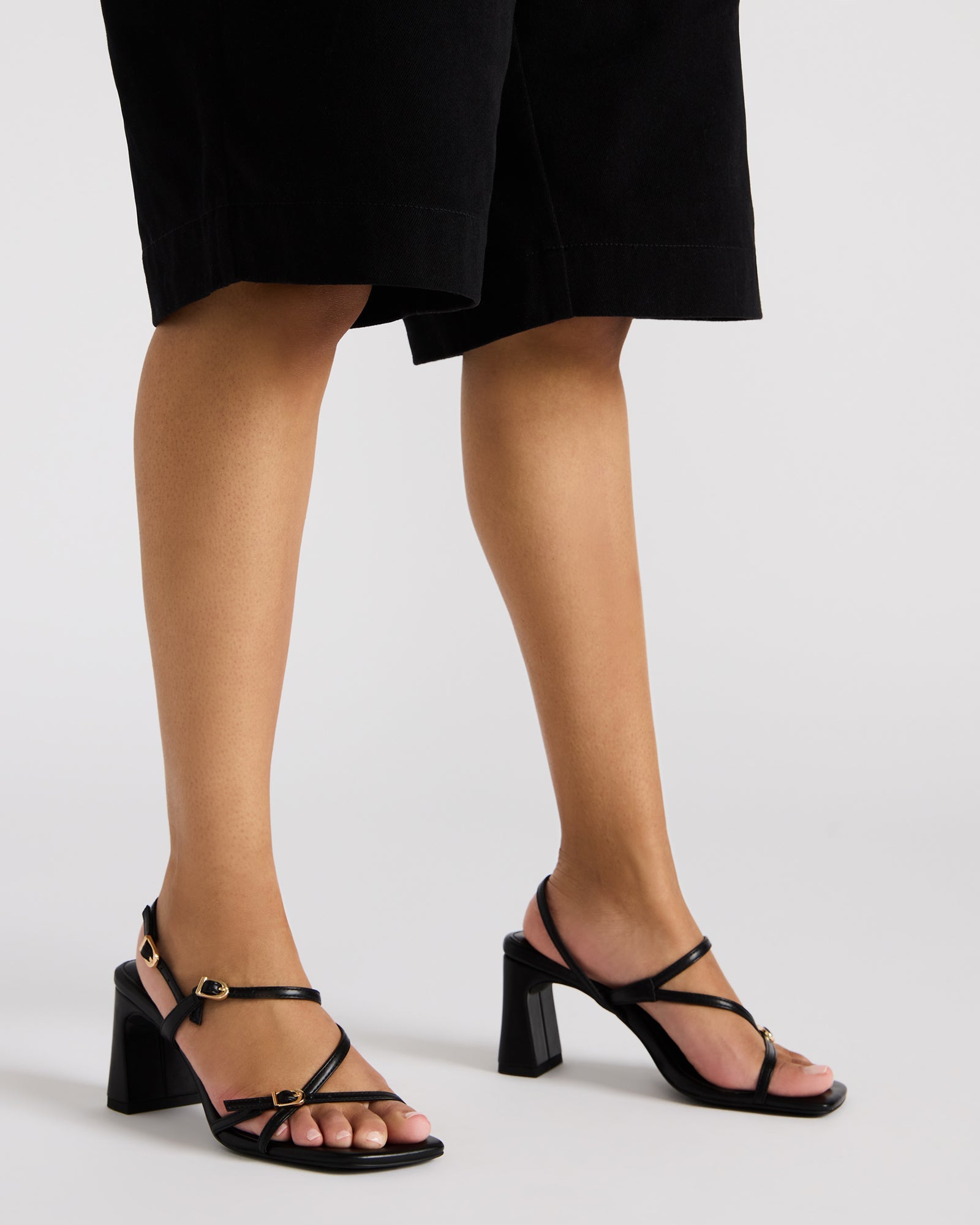 Close-up of vegan leather black square toe heels with modern design.