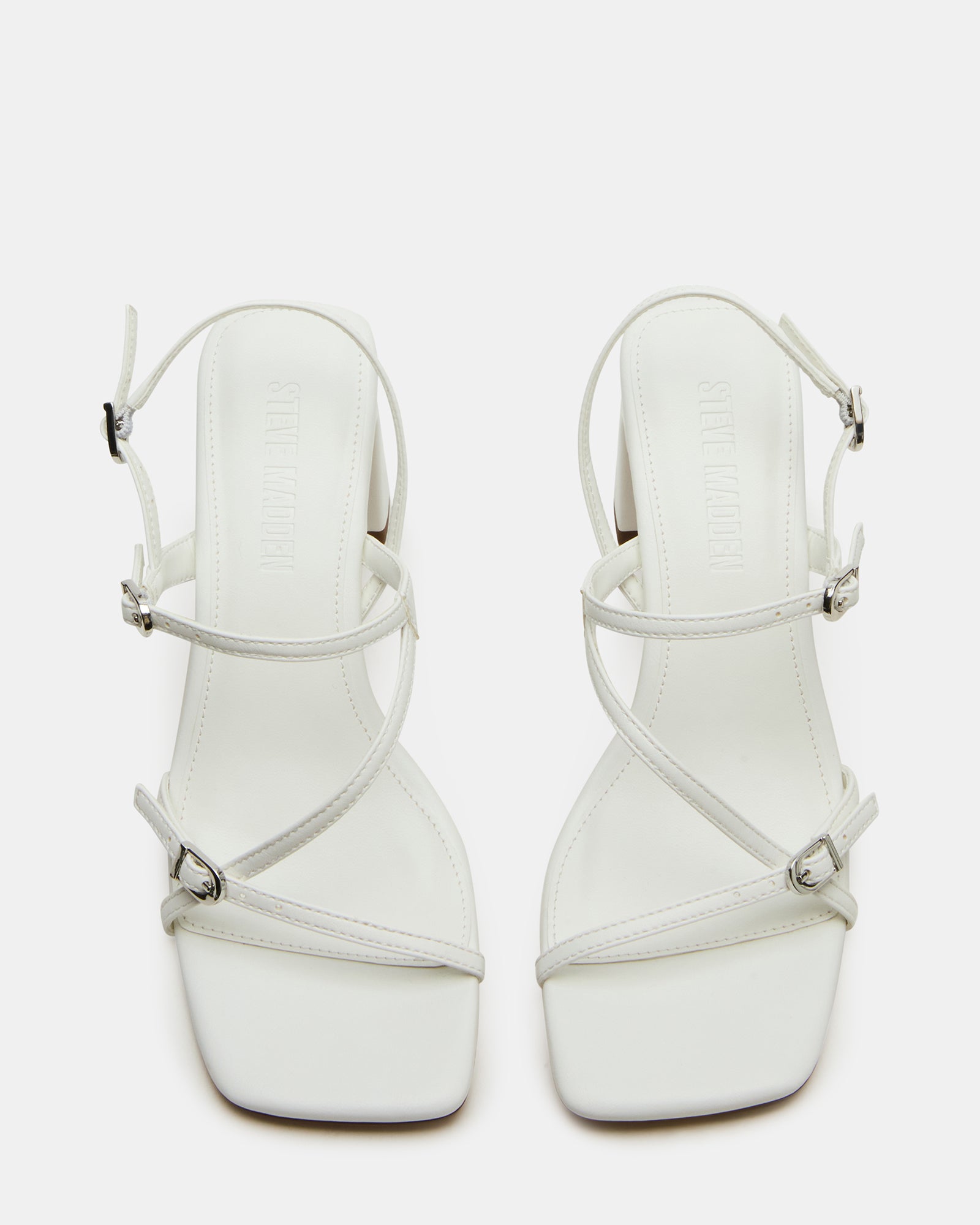 Side view of white slingback heels with square toe and buckle strap